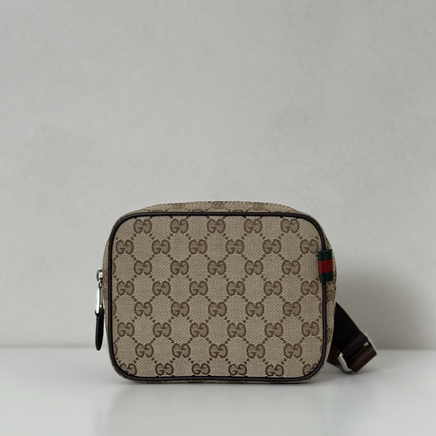 Gucci Ophidia GG Supreme canvas crossbody bag in beige and brown with the signature Web stripe.