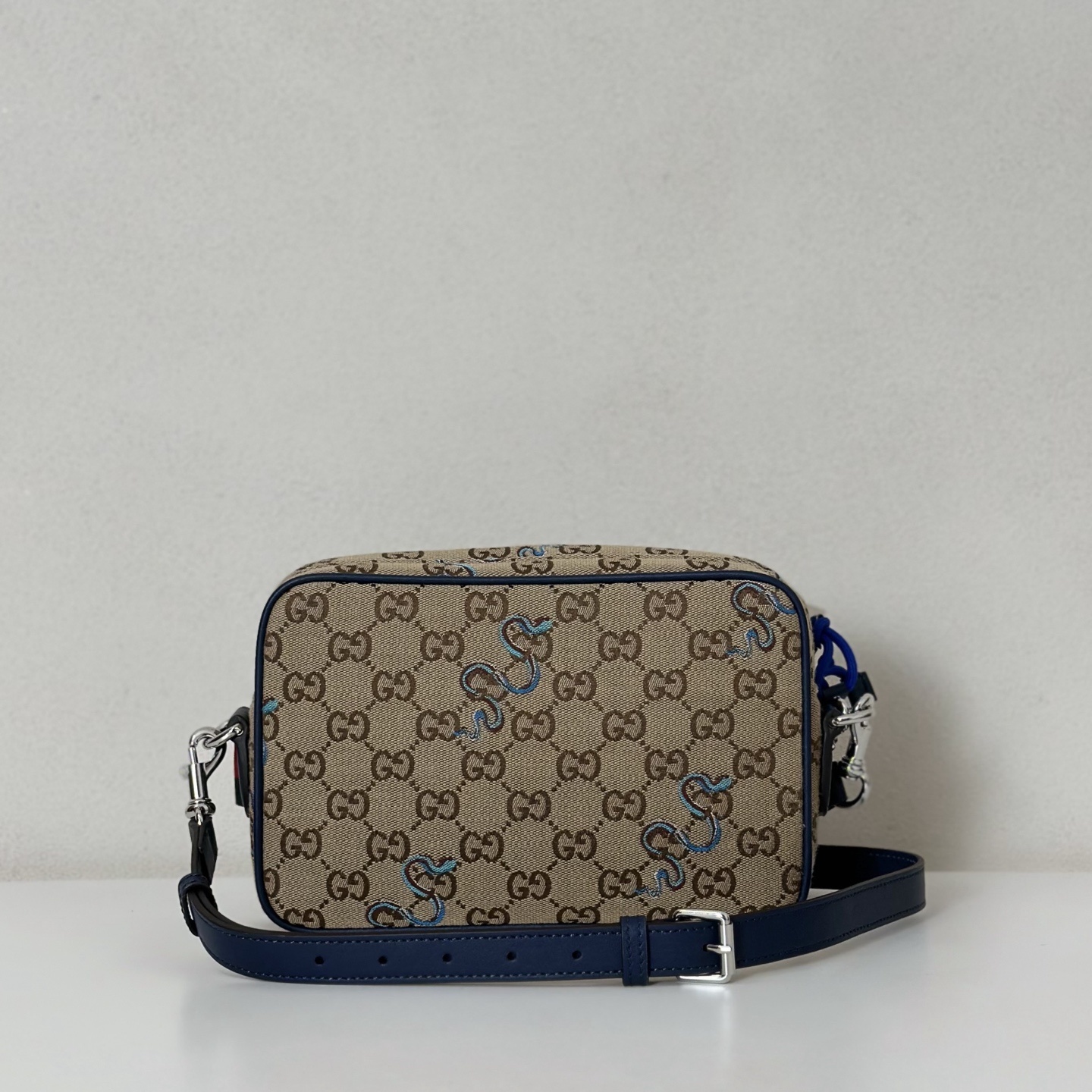 Gucci GG Supreme canvas crossbody bag with a blue embroidered snake motif