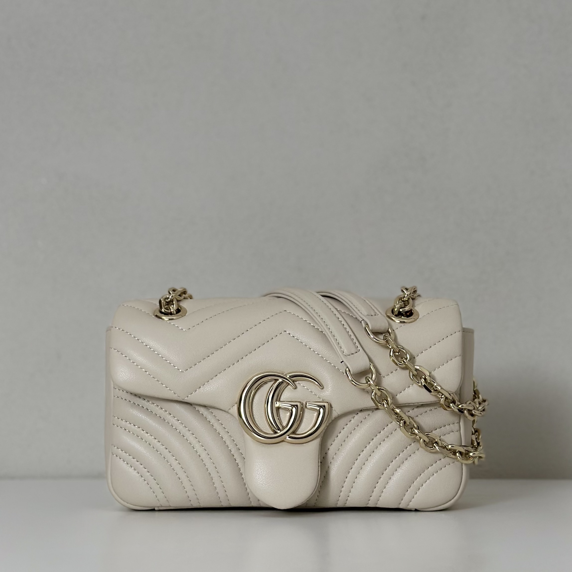 Gucci GG Marmont small or mini shoulder bag in cream or white matelassé leather with antique gold-toned hardware