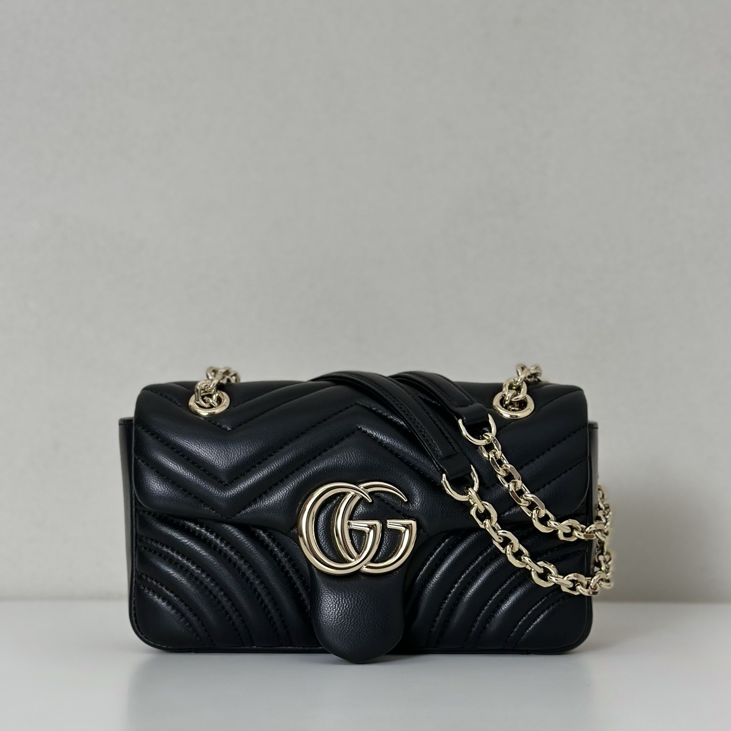 Gucci GG Marmont small shoulder bag in black matelassé leather with antique gold-toned hardware