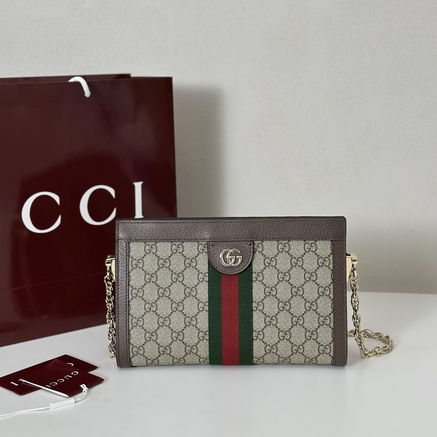 Gucci Ophidia small shoulder bag in beige and brown GG Supreme canvas with a green and red Web stripe, brown leather trim, and gold-toned hardware