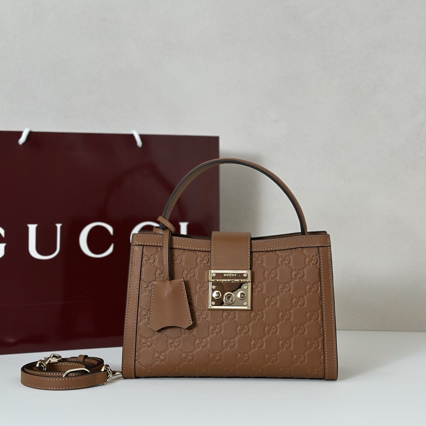 Gucci Padlock medium top handle bag in brown embossed GG leather with light gold-toned hardware