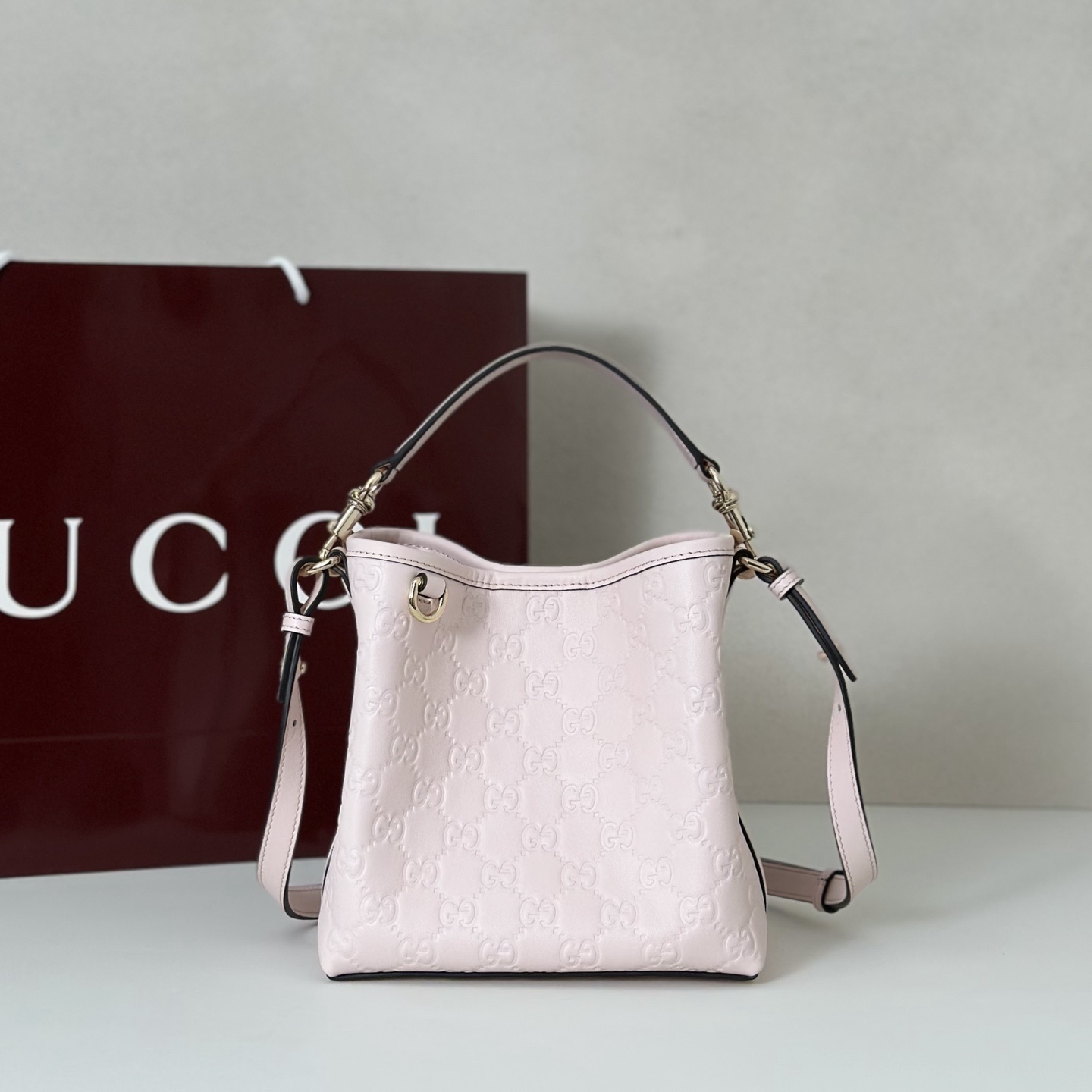 Gucci GG Emblem small bucket bag in pink GG leather