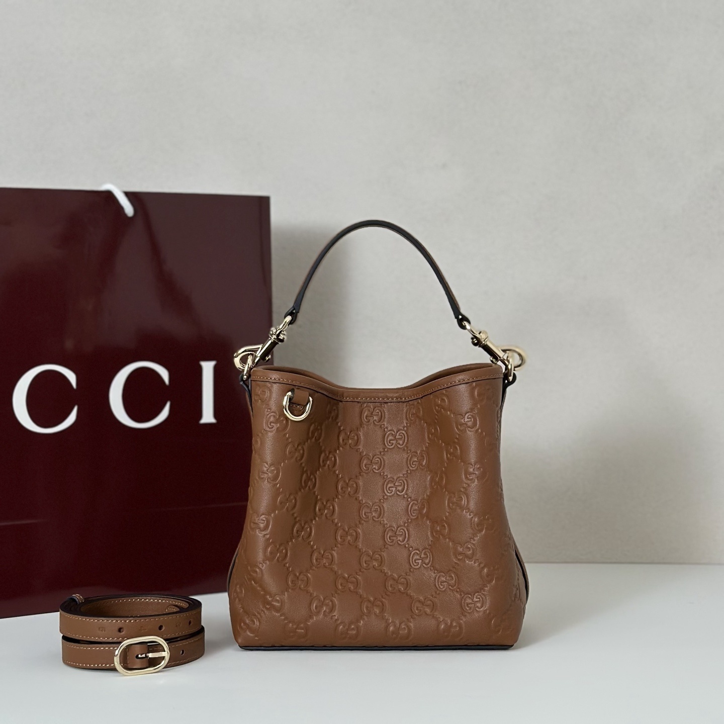 Gucci GG Emblem small bucket bag in brown leather