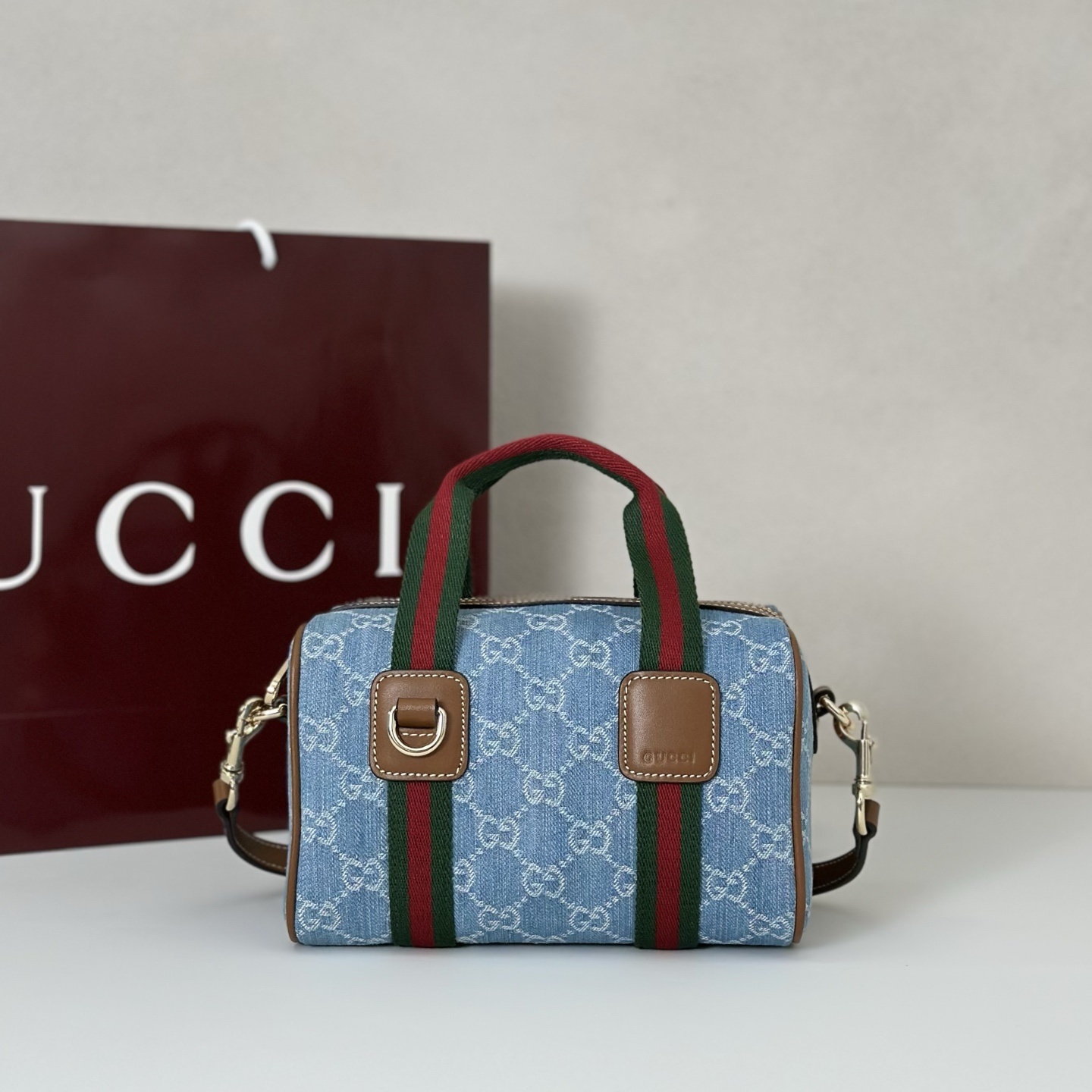 Gucci Ophidia Mini GG top handle bag in blue denim with the signature green and red Web stripes