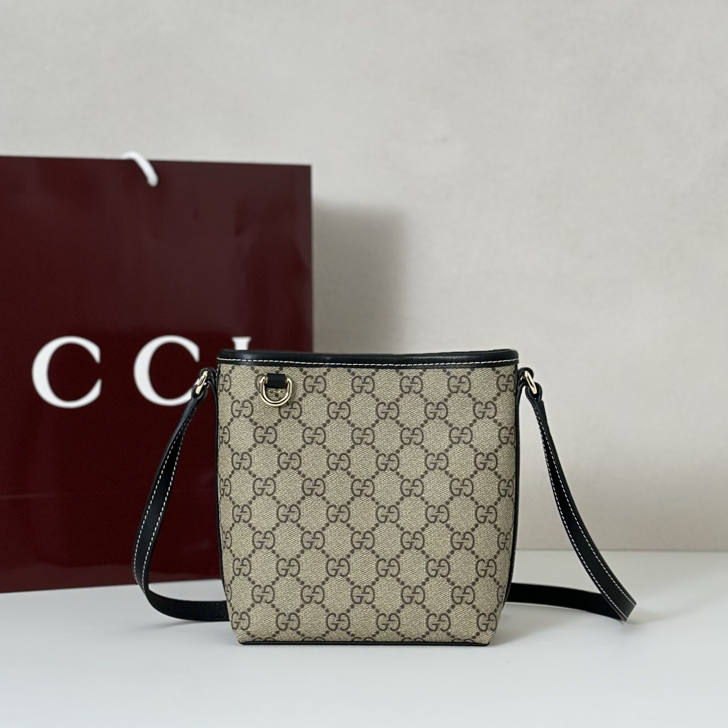Gucci GG Emblem nano bucket bag in beige and dark brown new GG monogram coated fabric with brown leather trim