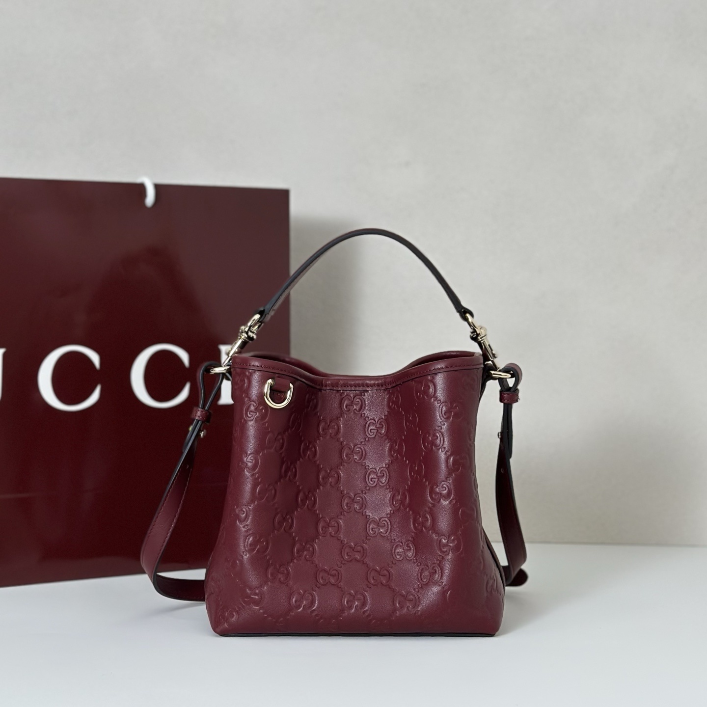 Gucci GG Emblem small bucket bag in burgundy leather