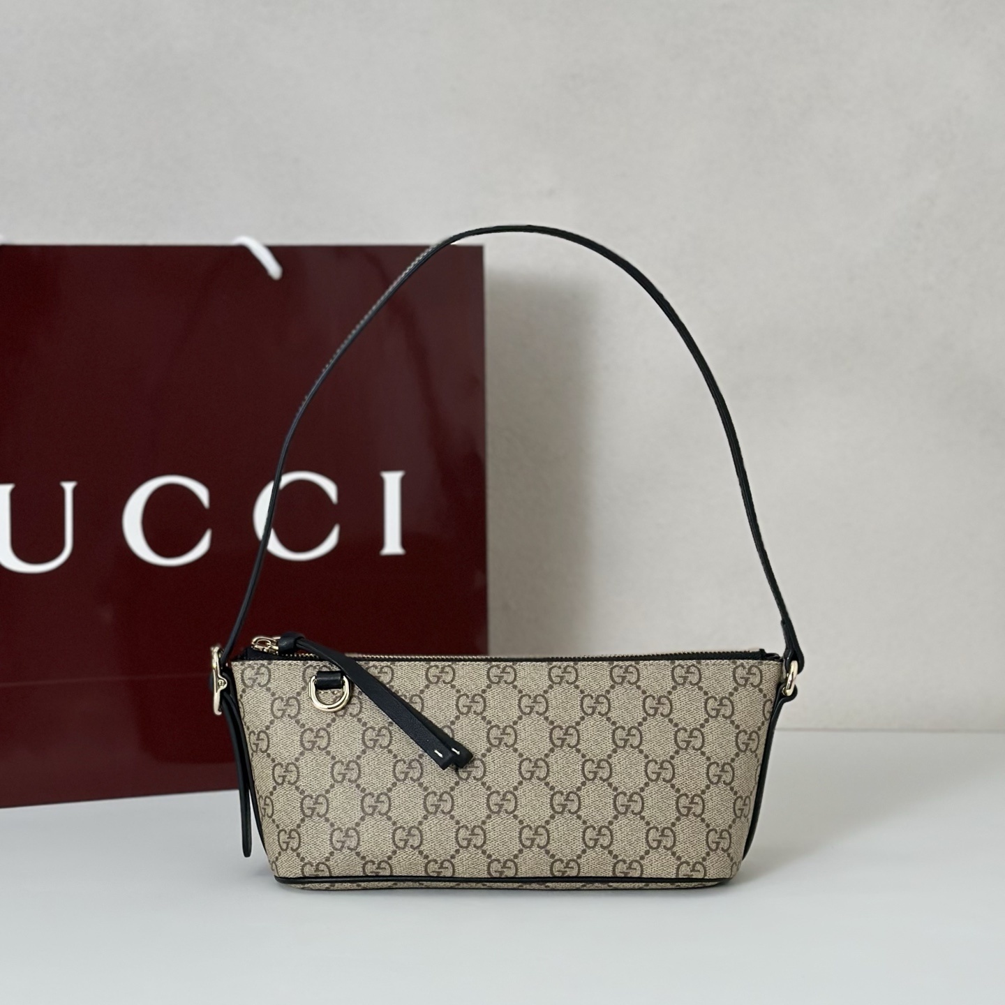 Gucci GG Emblem small shoulder bag in beige and dark brown GG Monogram coated fabric with brown leather trim