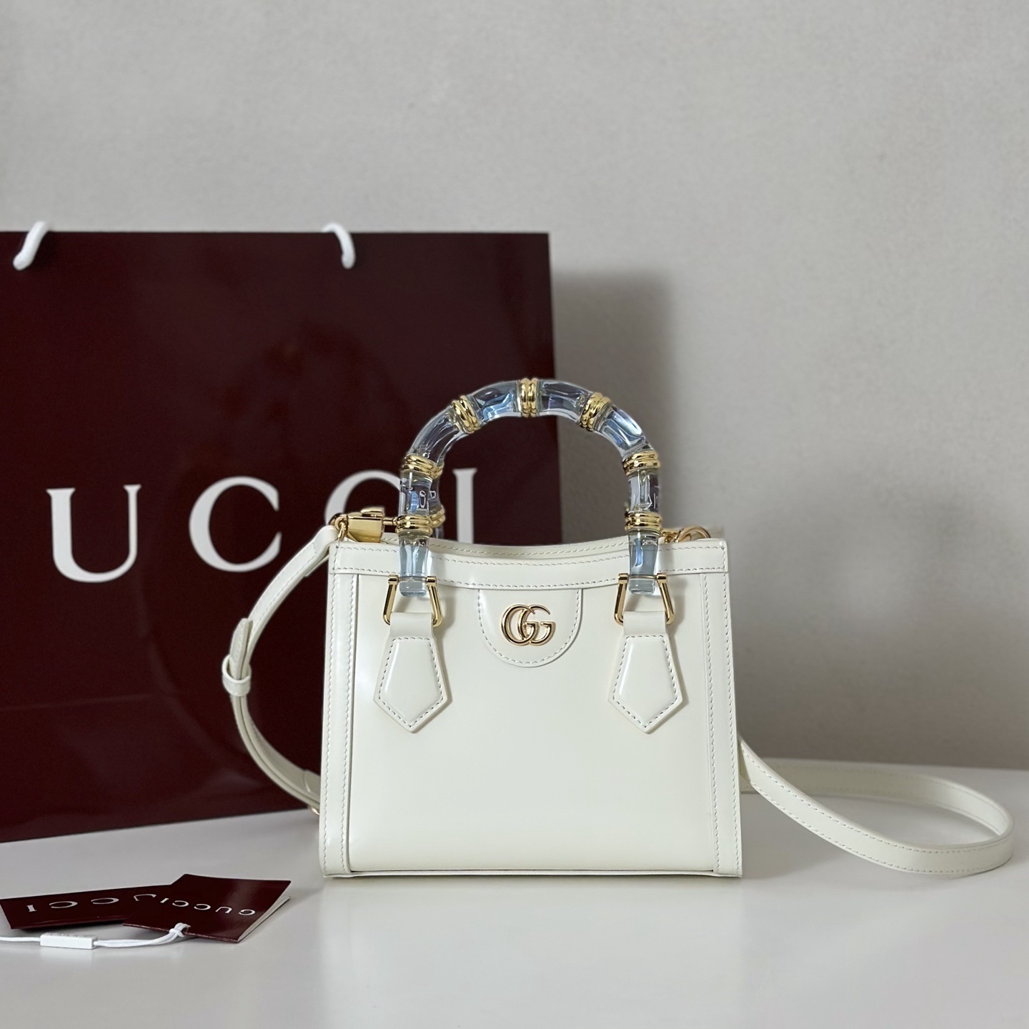 Gucci Diana mini tote bag in white leather with a clear resin bamboo handle