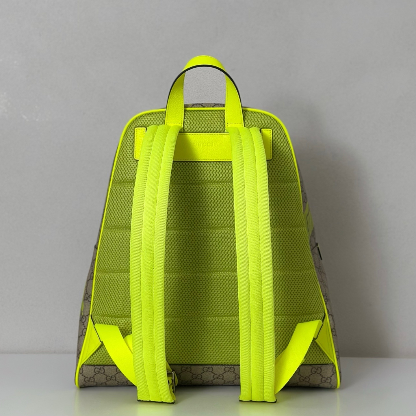 Gucci GG Supreme canvas backpack with a yellow "Gucci!" print