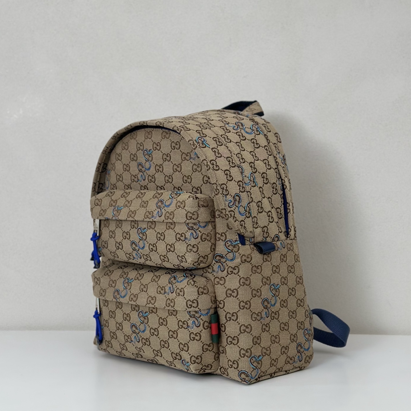 Gucci GG Supreme canvas backpack with blue doodle-style accents