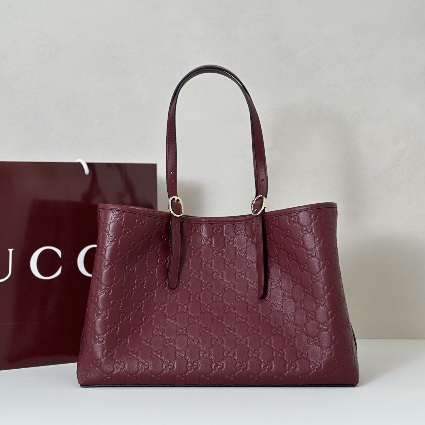 Gucci GG Emblem large tote bag in a deep red color