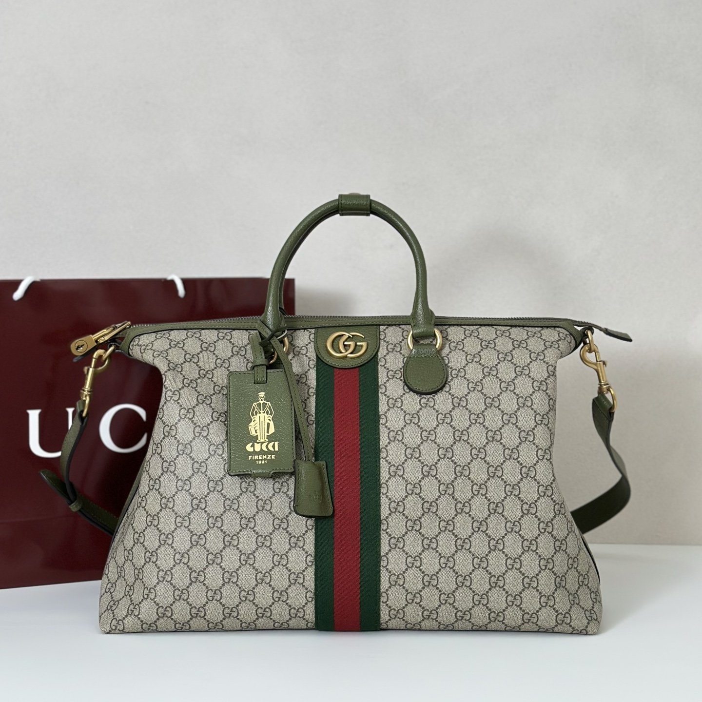 Gucci Savoy medium duffle bag in beige GG Supreme canvas with green leather trim and the signature Web stripe detailing