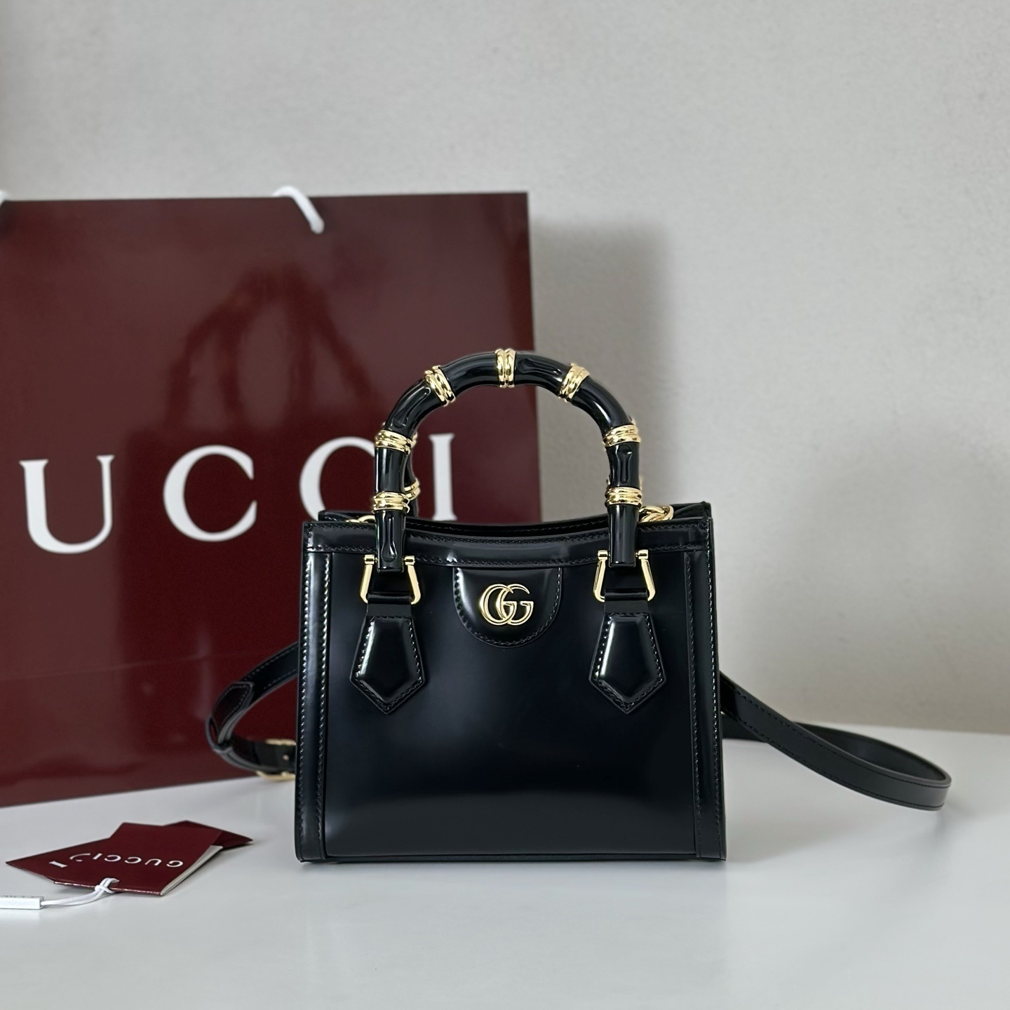 Gucci Diana mini tote bag in black leather with gold-toned hardware and bamboo handles