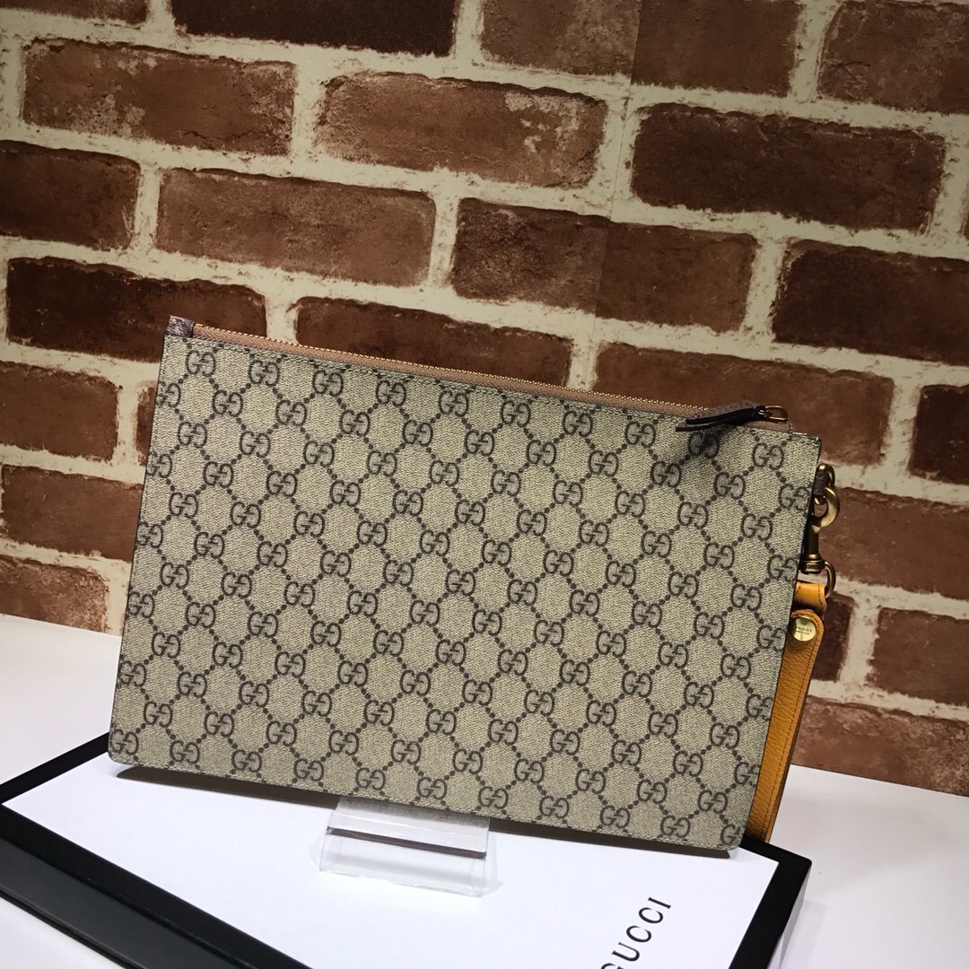 Gucci Neo Vintage GG Supreme Zip Wristlet Pouch in beige monogram coated canvas with a yellow leather wristlet strap and a feline head detail