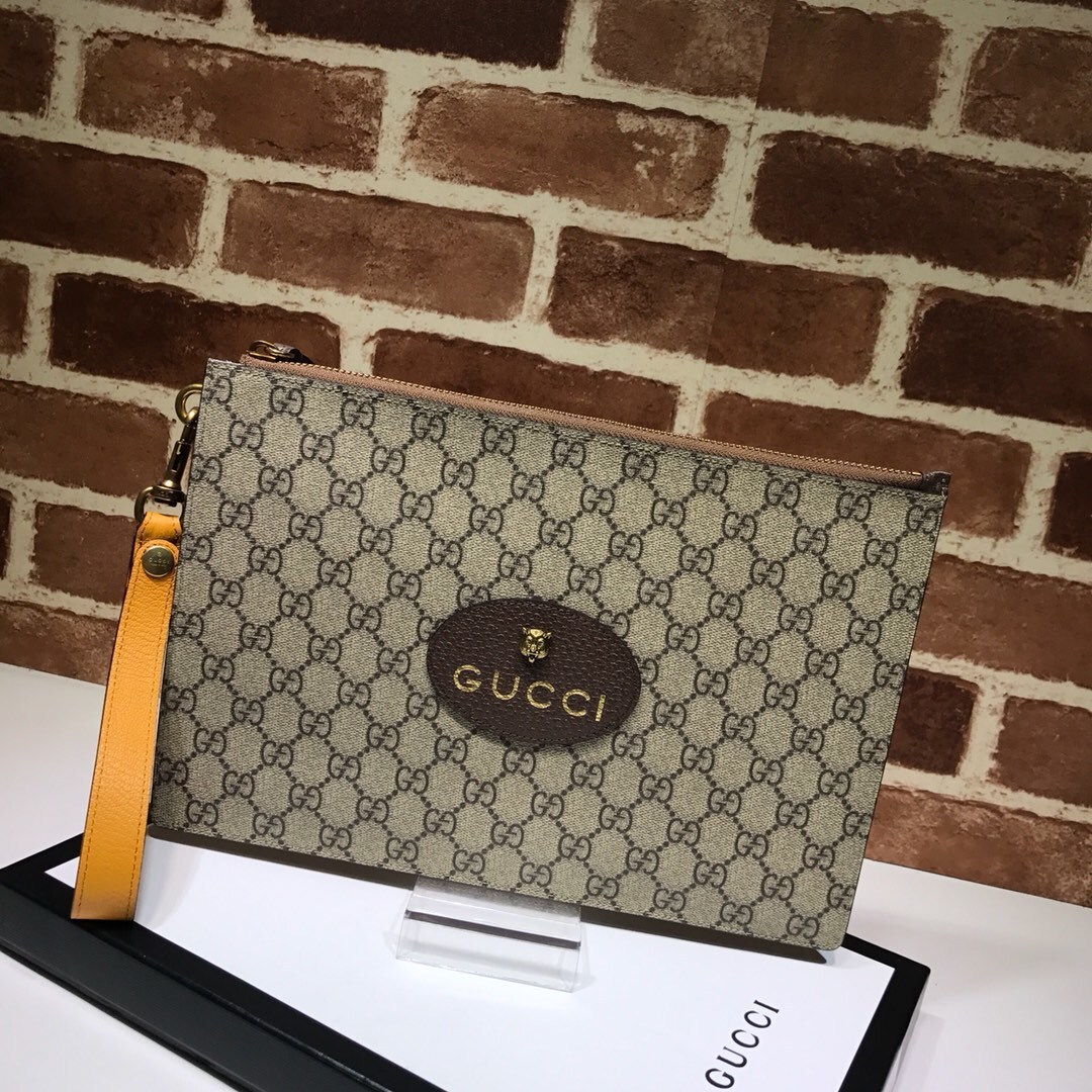 Gucci Neo Vintage GG Supreme Zip Wristlet Pouch in beige monogram coated canvas with a yellow leather wristlet strap and a feline head detail
