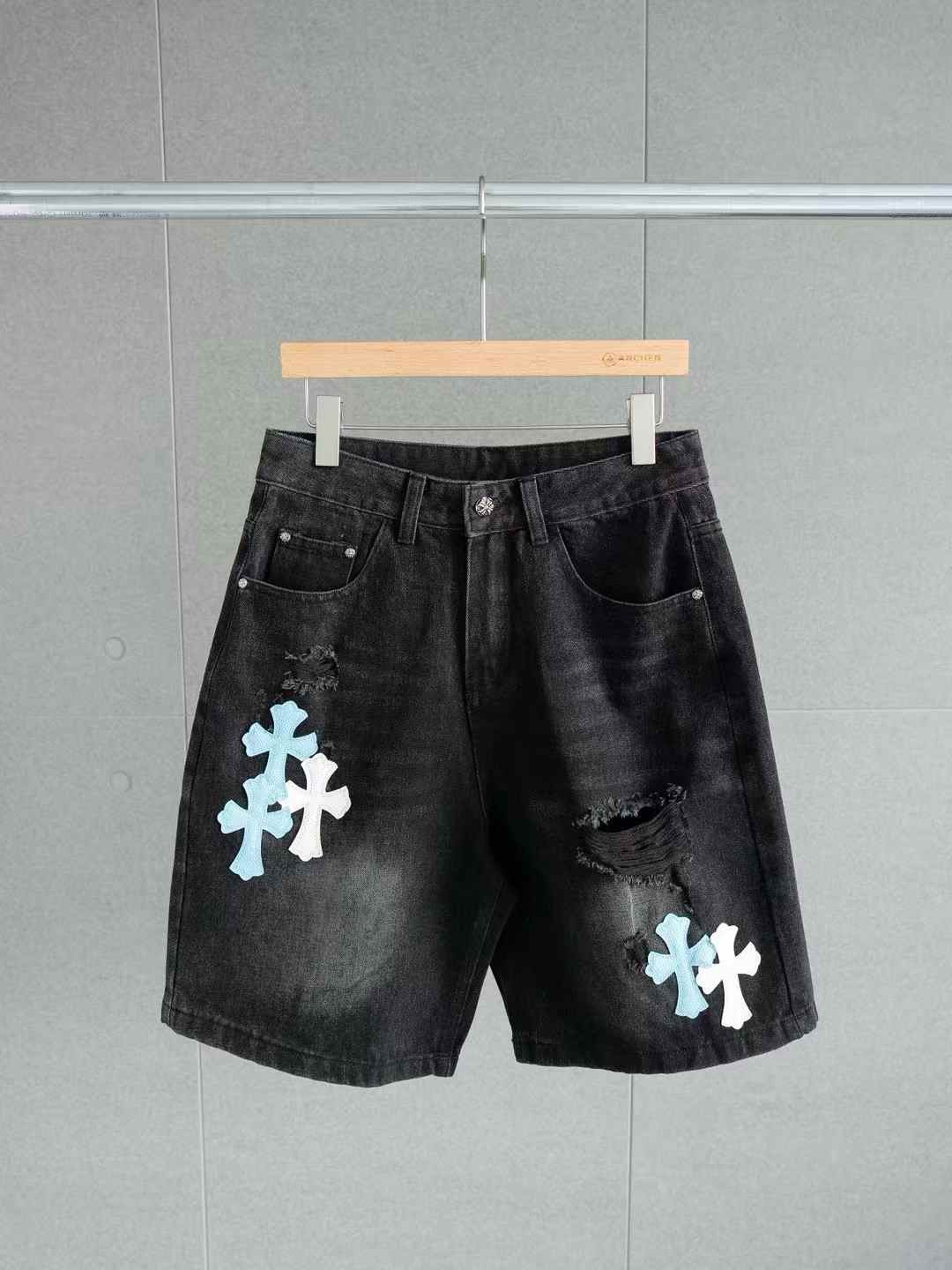 Chrome Hearts black denim shorts with white and light blue cross patches