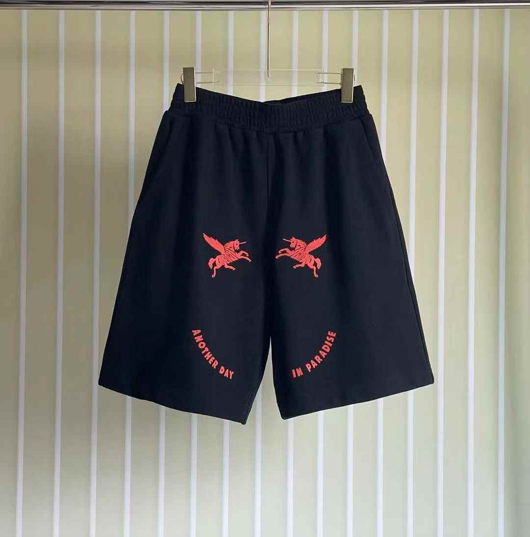 burberry black shorts with red unicorn-pegasus embroidery and "ANOTHER DAY IN PARADISE" text details.