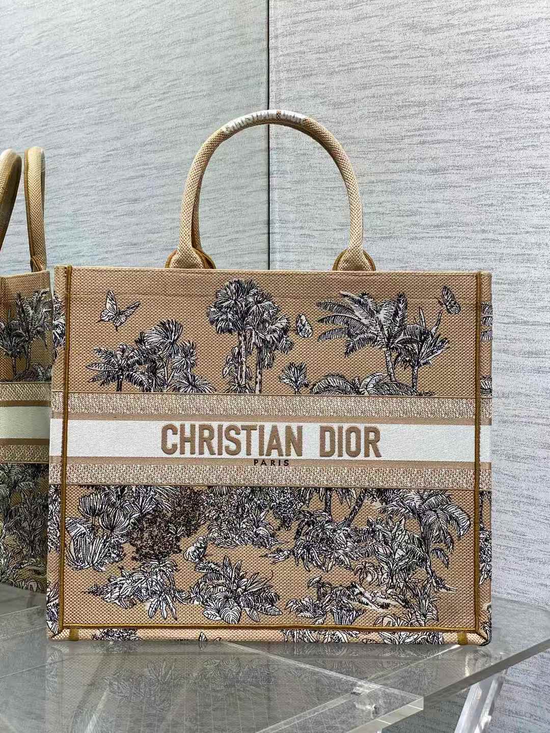 Christian Dior Book Tote bag in a beige jute material with a black and white "Garden" or "Toile de Jouy" pattern