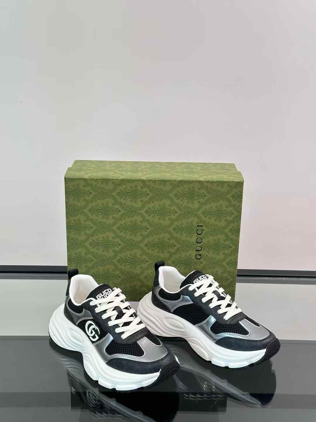 gucci black and silver-toned sneakers with a white chunky sole