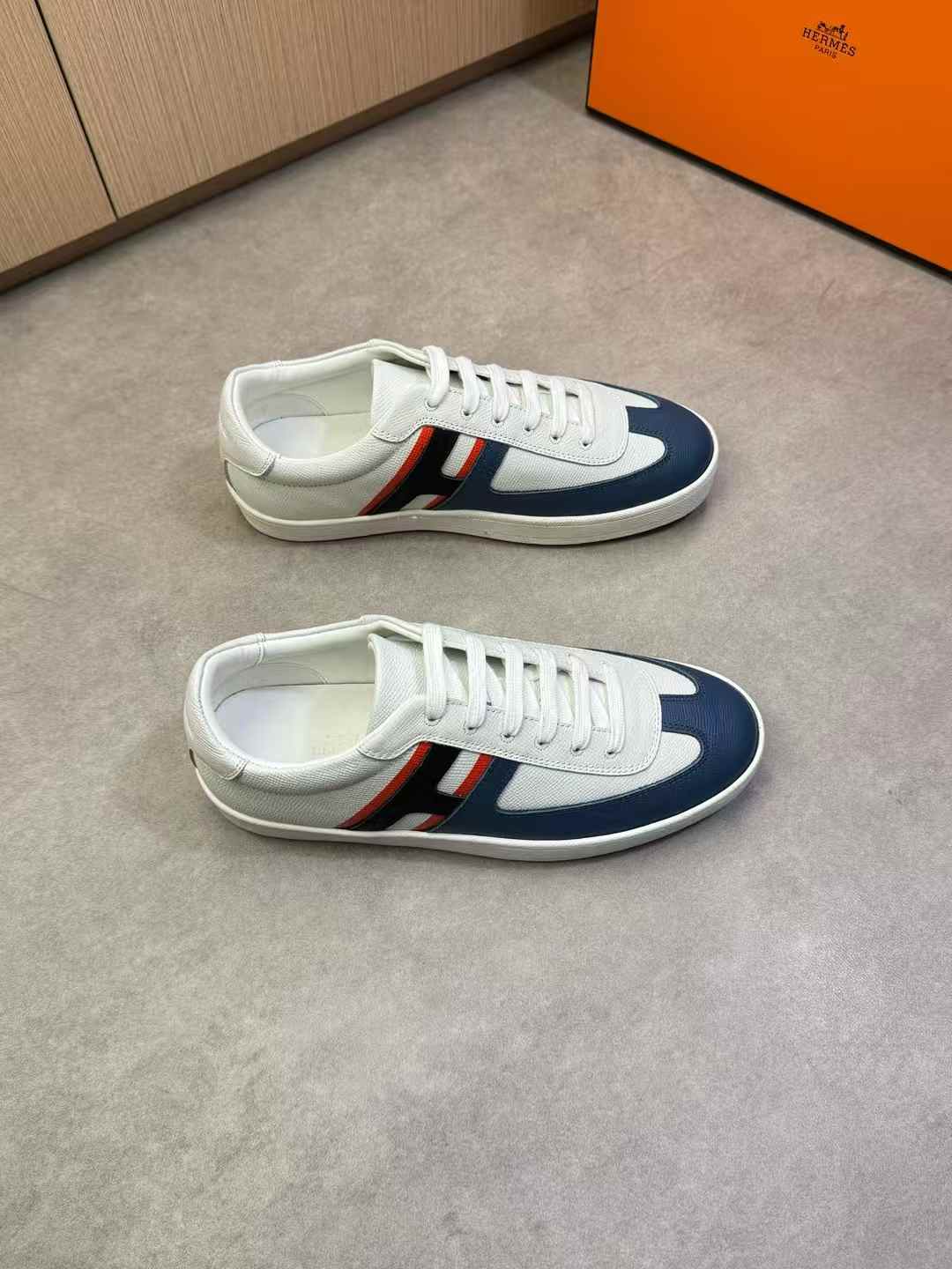 Hermes Boomerang sneakers in white Epsom calfskin with a blue toe and the iconic orange sole