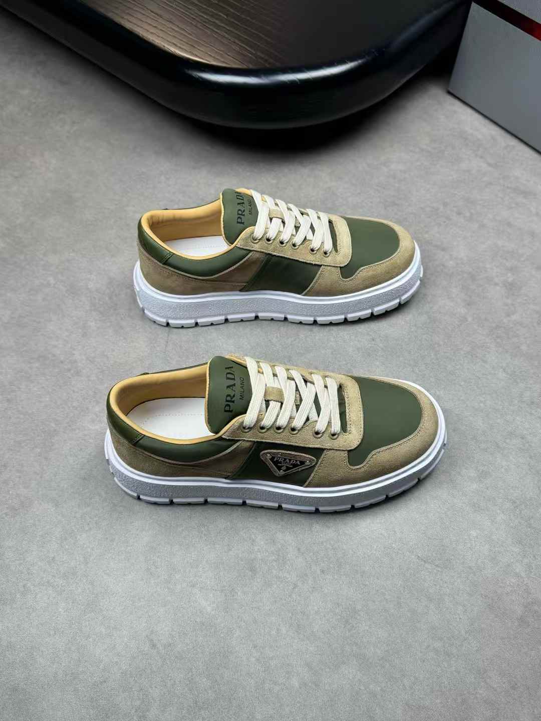 Prada Downtown leather sneakers in a white and mango green (olive green/khaki) colorway