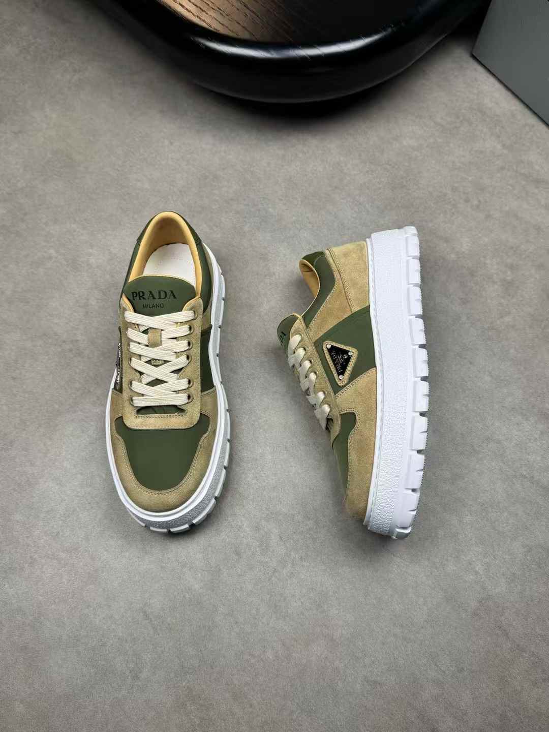 Prada Downtown leather sneakers in a white and mango green (olive green/khaki) colorway