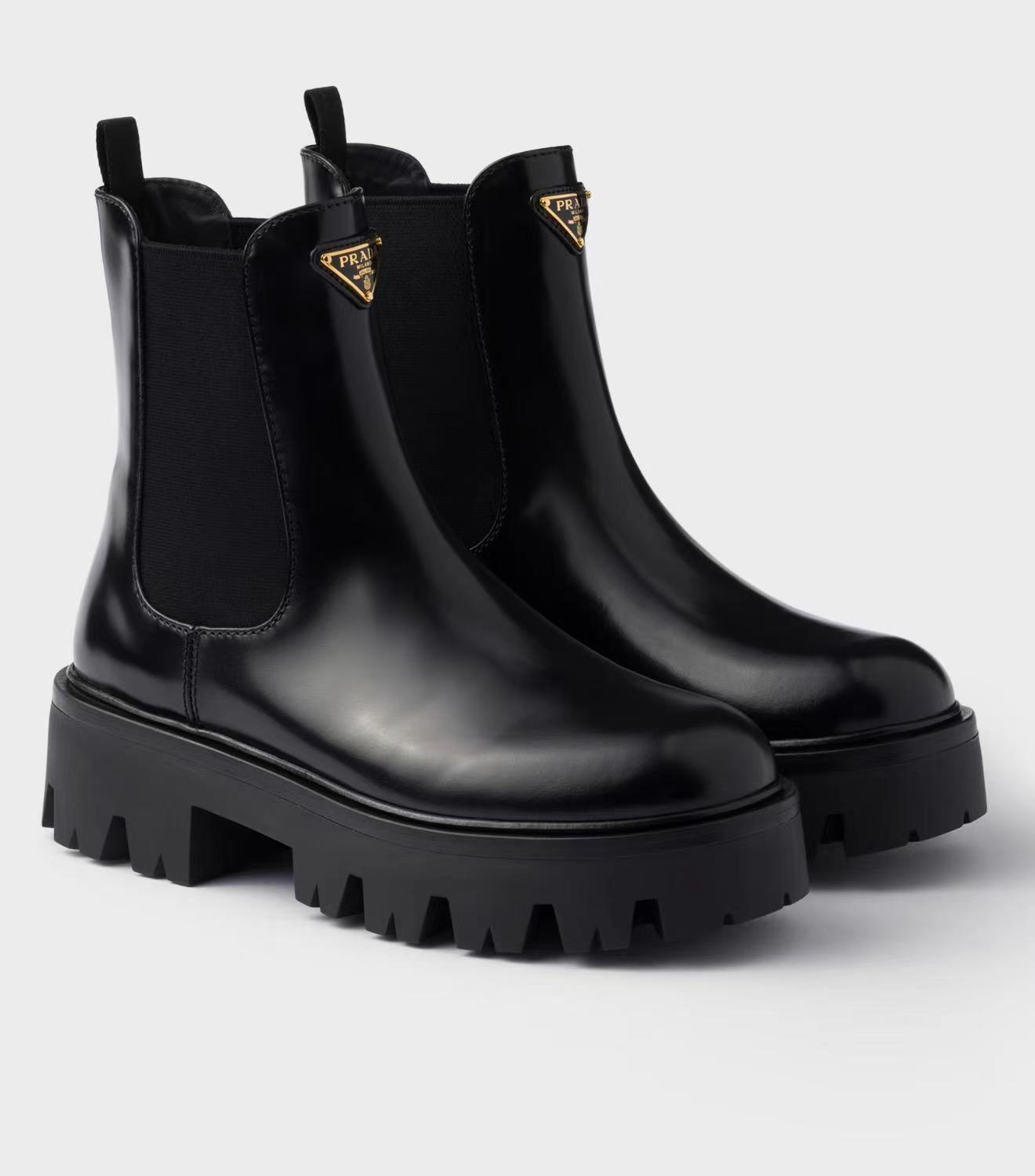 Prada brushed leather ankle boots Black iconic metal triangle logo and a chunky rubber sole