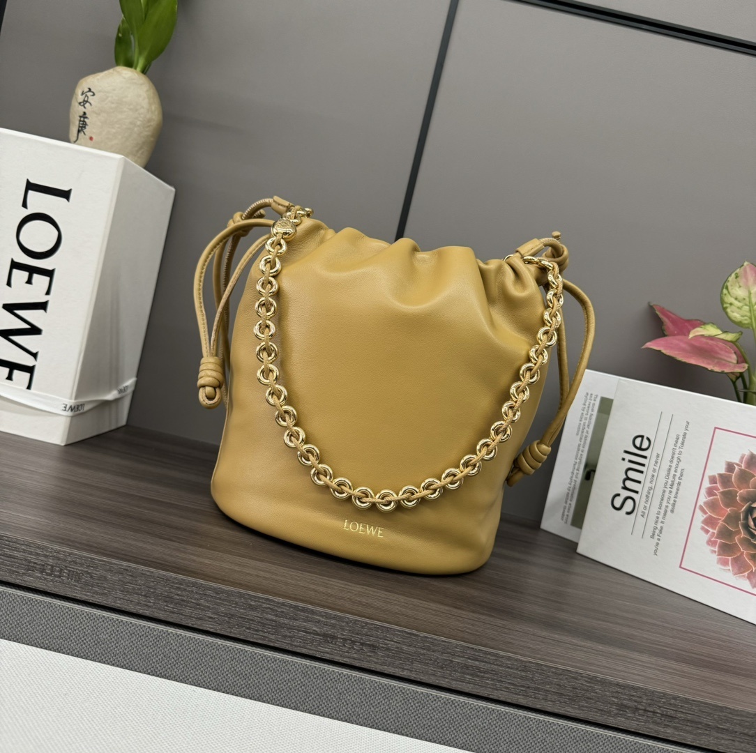Loewe Flamenco bucket bag in mustard yellow lambskin leather with a gold-toned chain-link shoulder strap