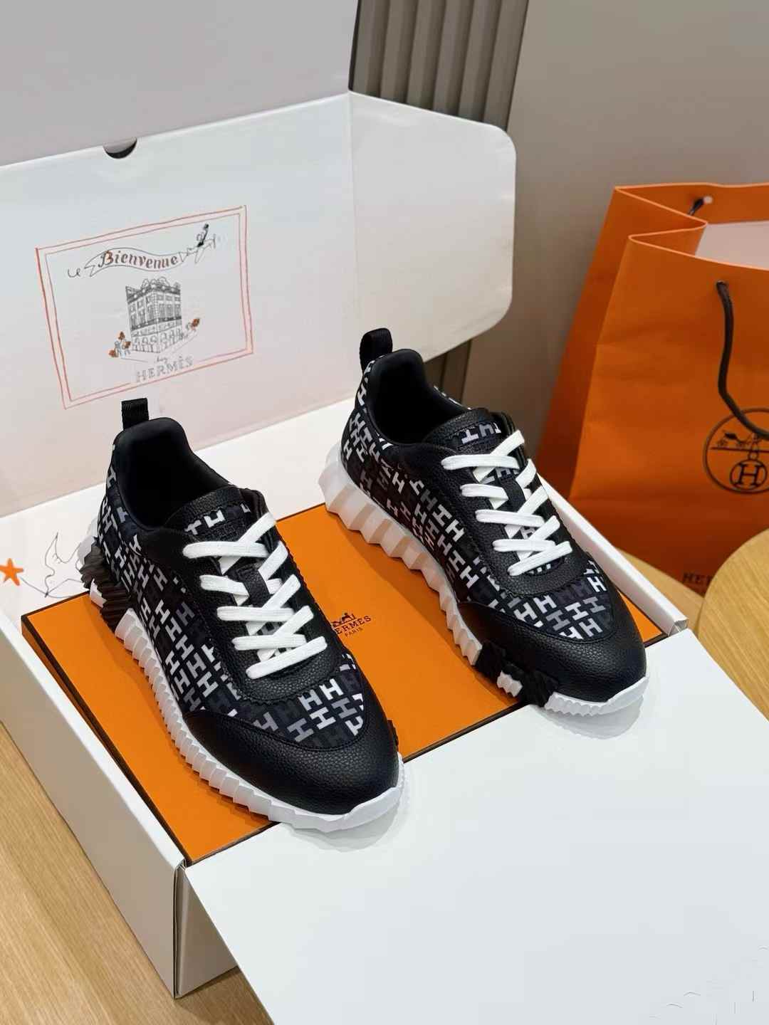 Hermès Bouncing sneaker in the black and white colorway with the signature "H en biais" motif.