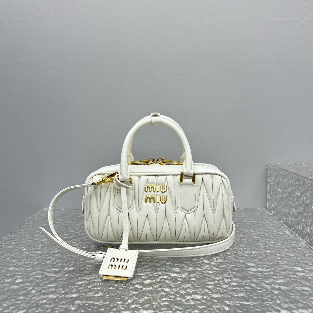 Miu Miu Arcadie matelasse nappa leather top-handle bag in white.