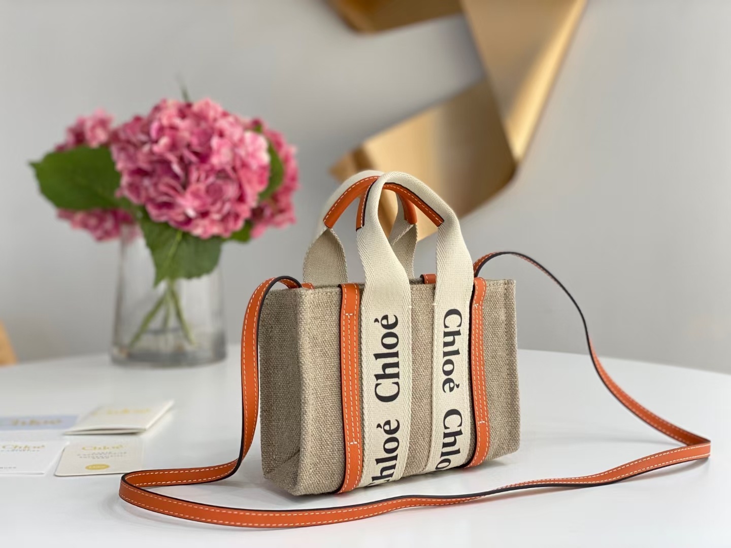 Chloe Woody mini tote bag in linen canvas and shiny calfskin with orange logo ribbons and leather trim