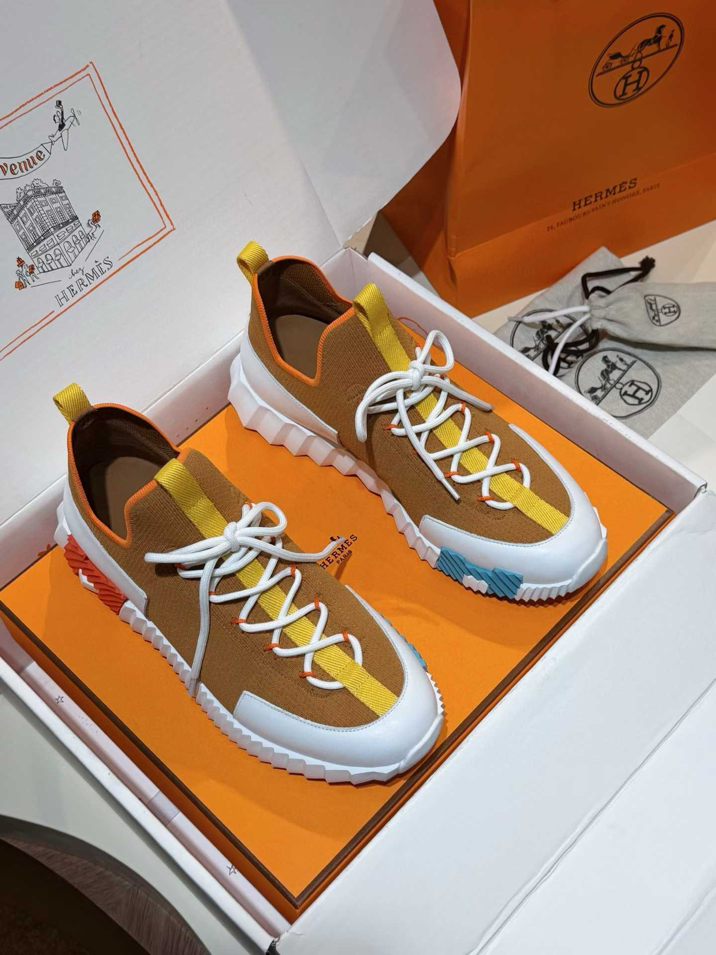 Hermès Lift slip-on sneakers in knit and calfskin with a contrasting graphical sole.