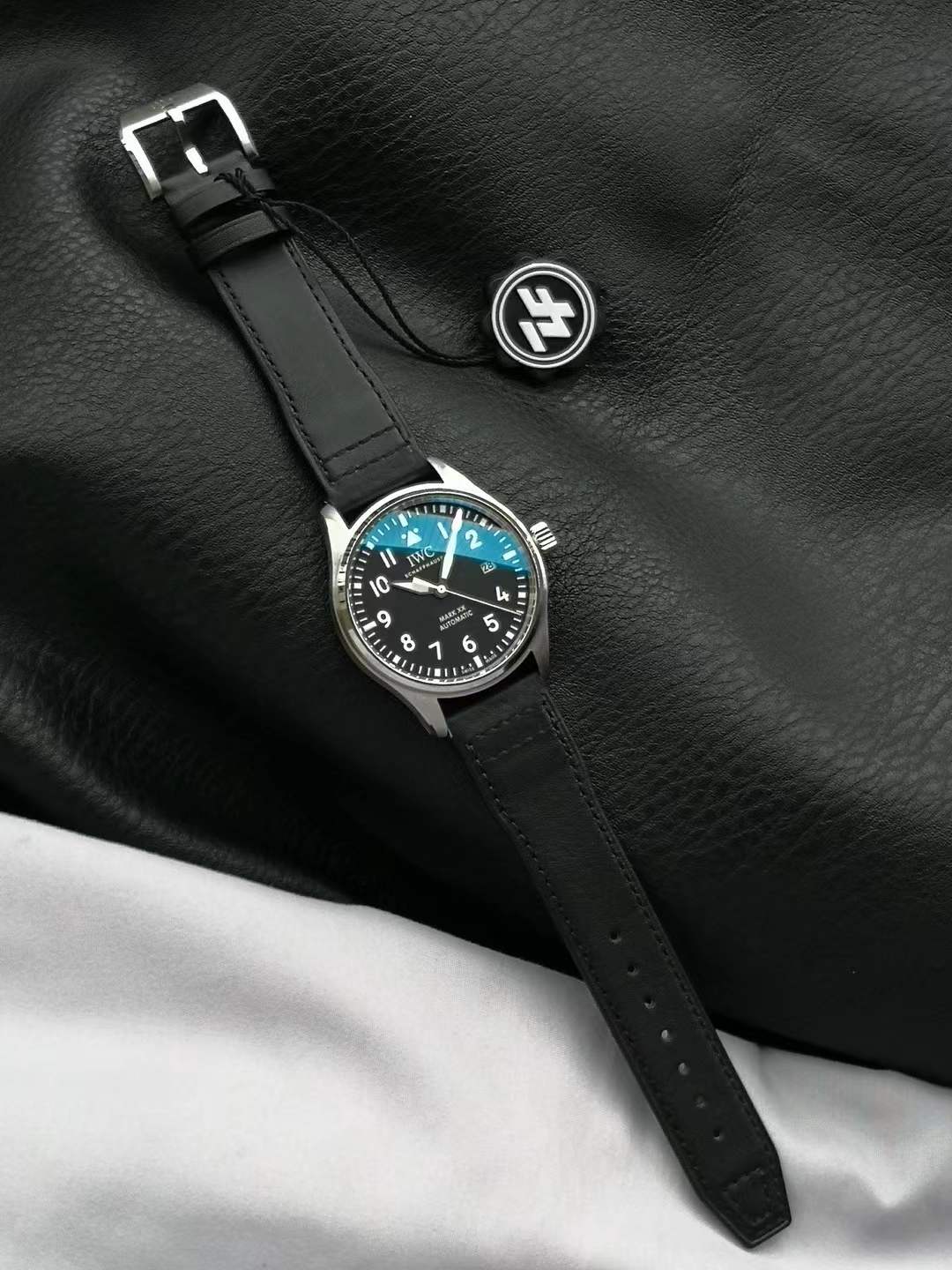 IWC Pilot's Watch Mark XX in stainless steel with a black dial and a black calfskin strap.