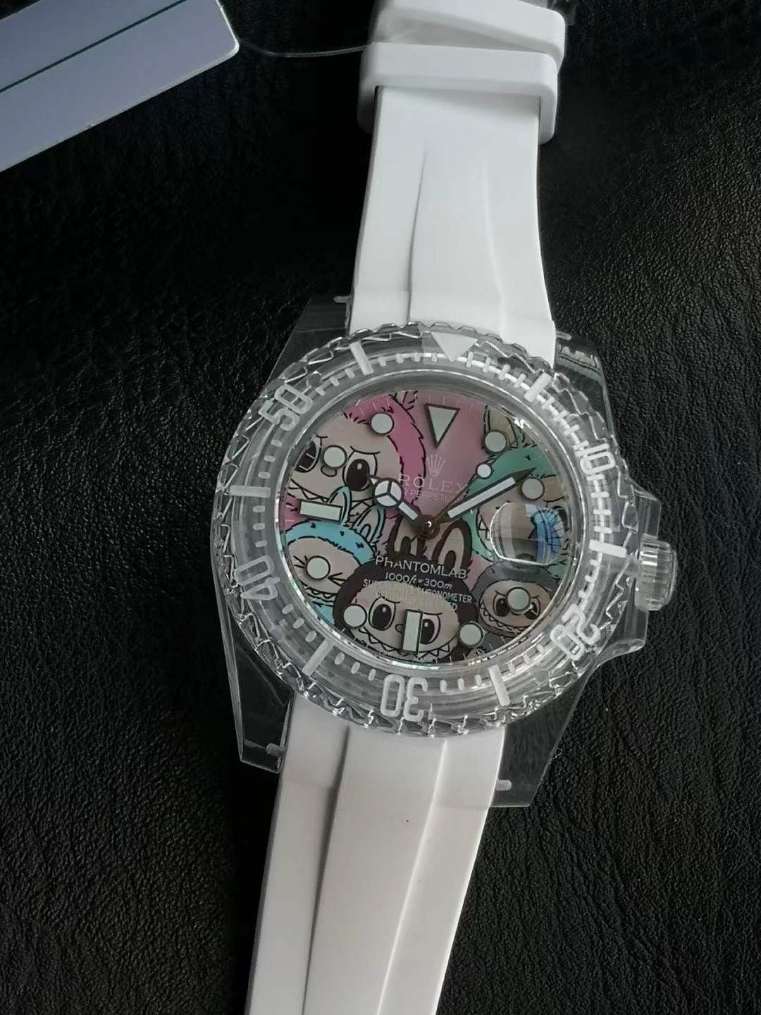 Rolex Chumbak wrist watch with a clear case and a white silicone strap, featuring a colorful, cartoon-style dial