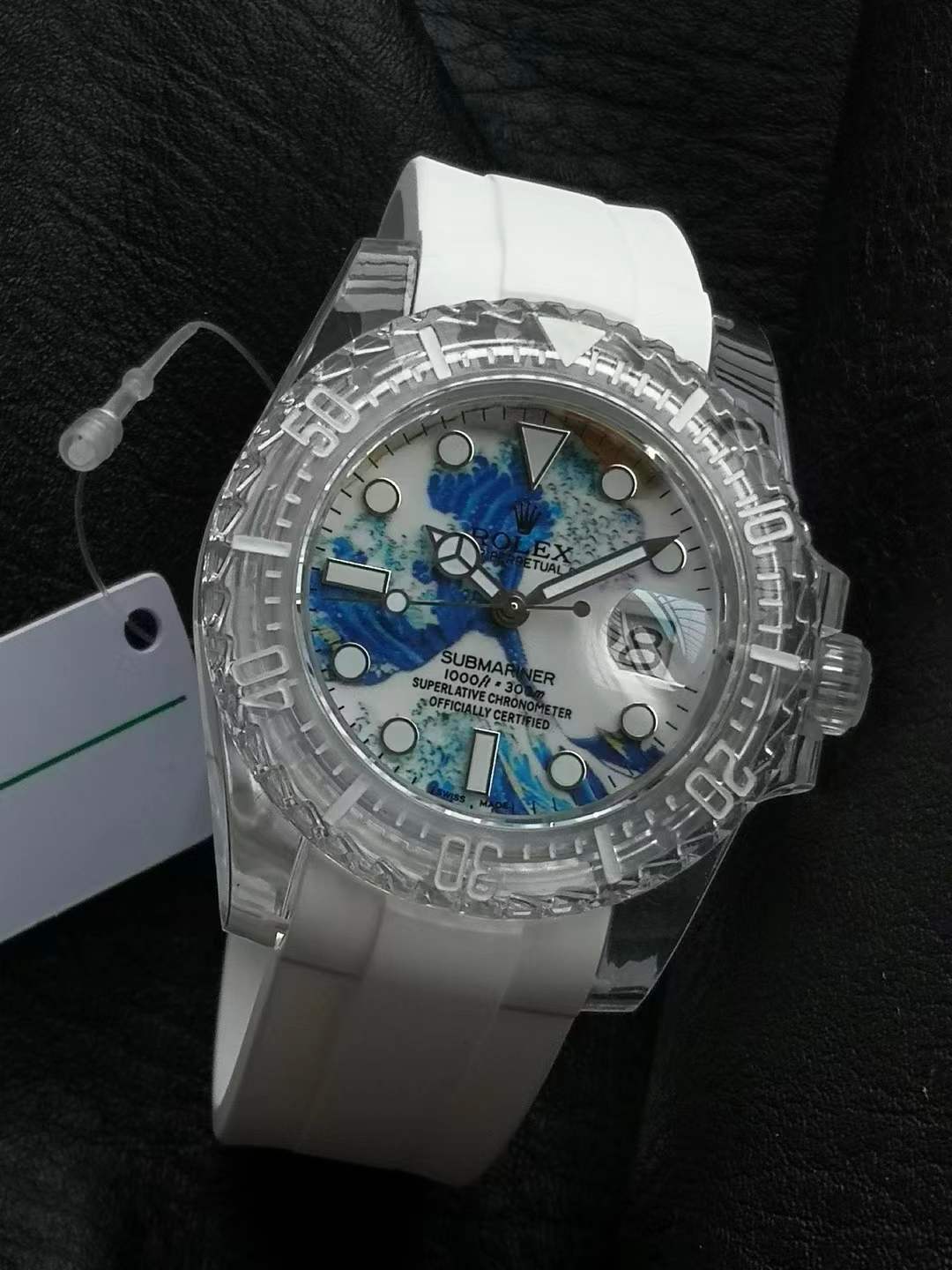 Rolex Submariner with a transparent or clear case and strap and a dial featuring an abstract blue and white wave design