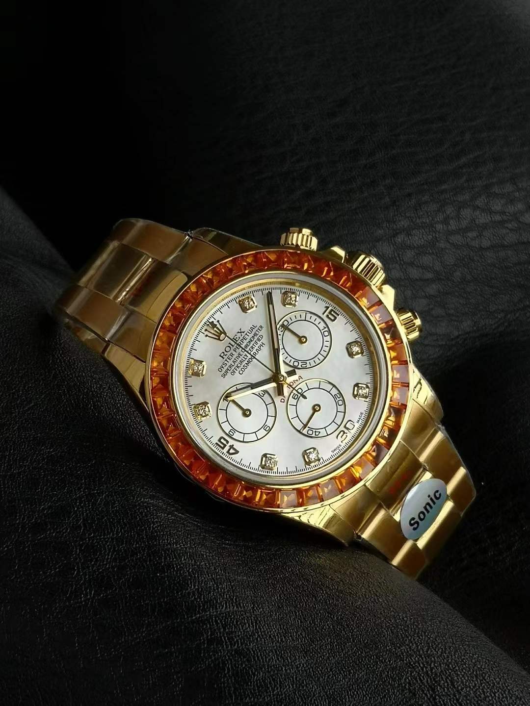Rolex Daytona 116578SACO, featuring a Mother of Pearl dial and a fiery orange sapphire-set bezel