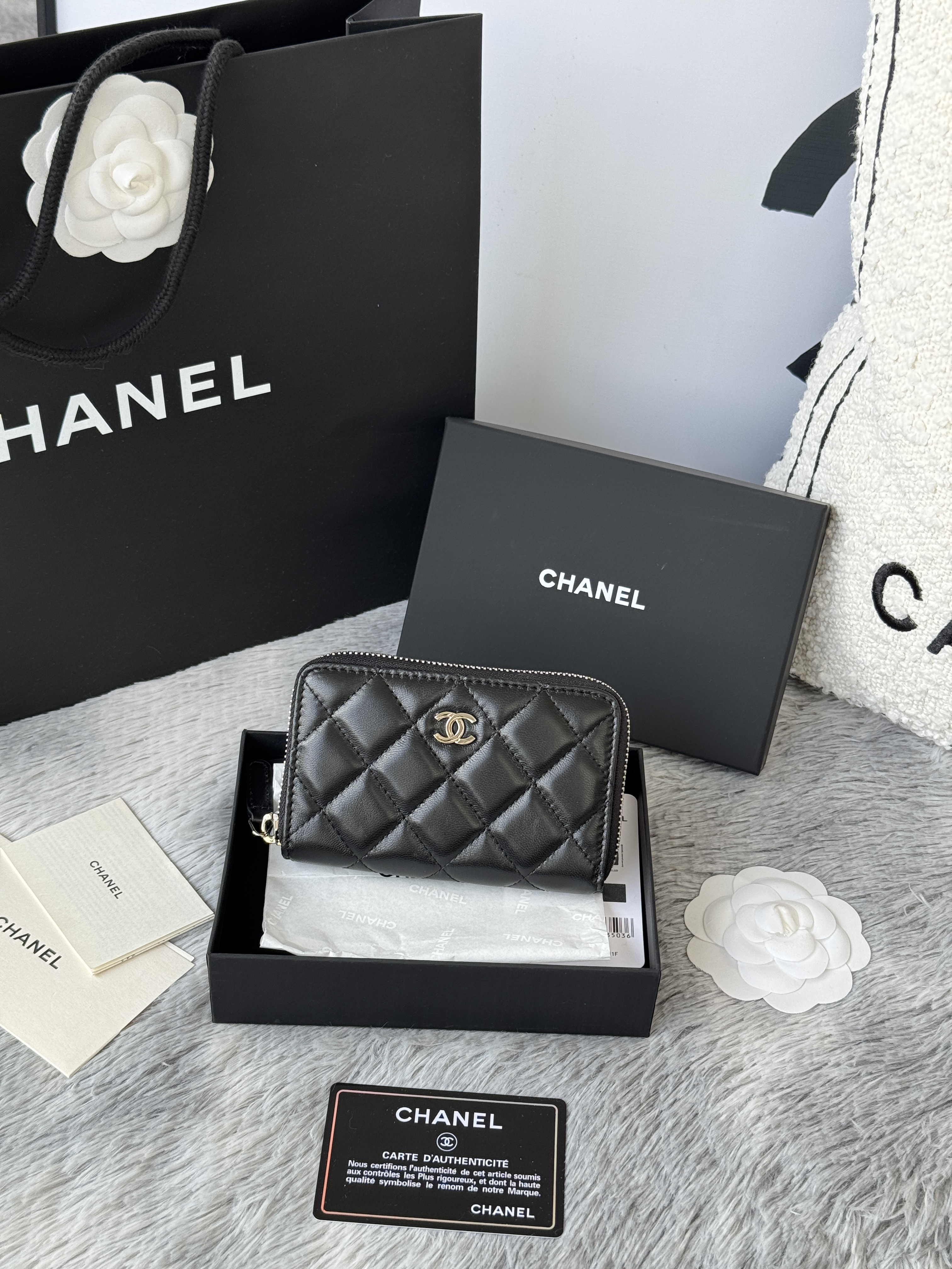 Chanel Classic Zipped Coin Purse in black lambskin or caviar leather with gold-tone hardware