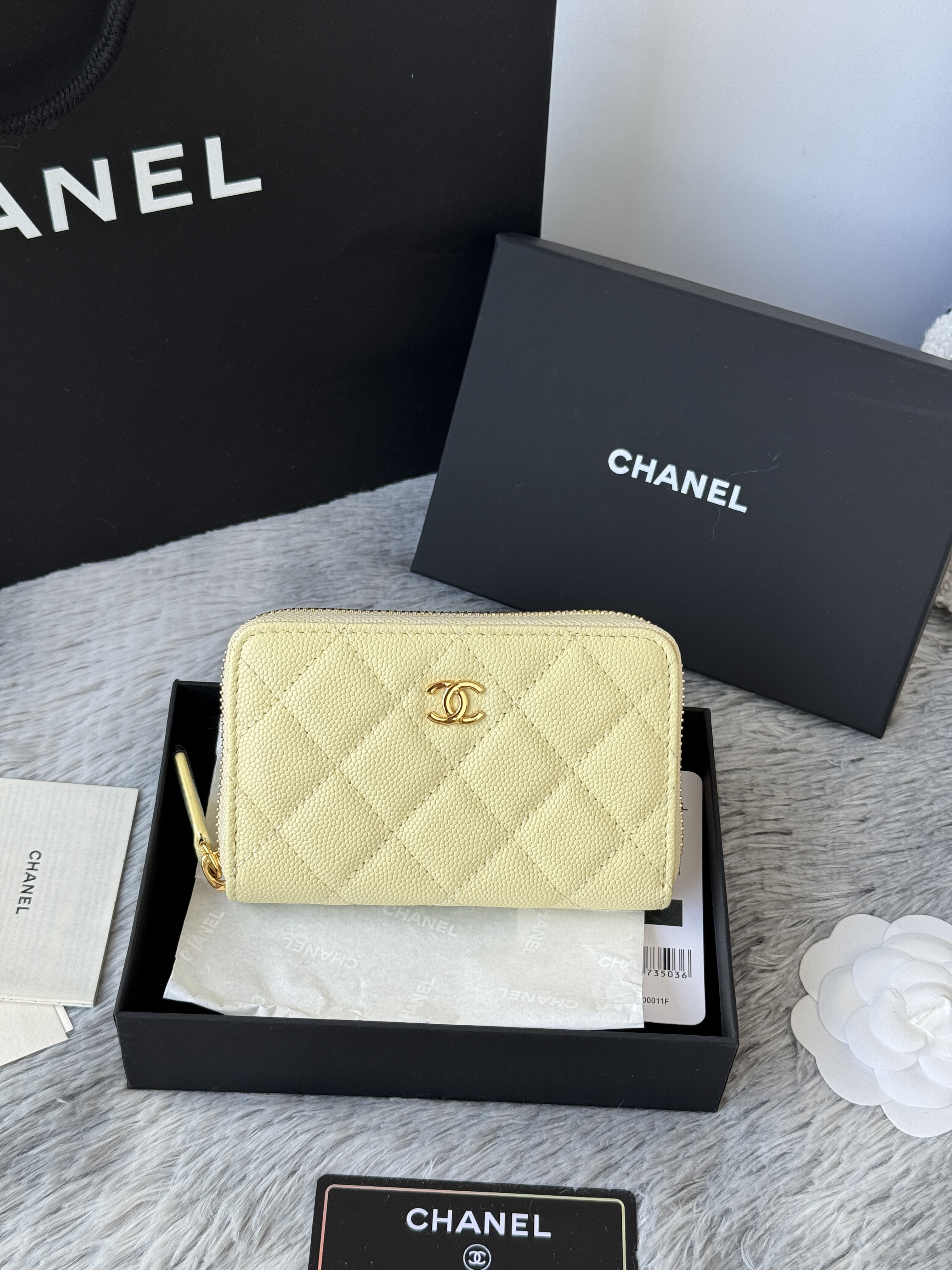 Chanel Classic Zipped Coin Purse in light yellow caviar leather with gold-tone hardware