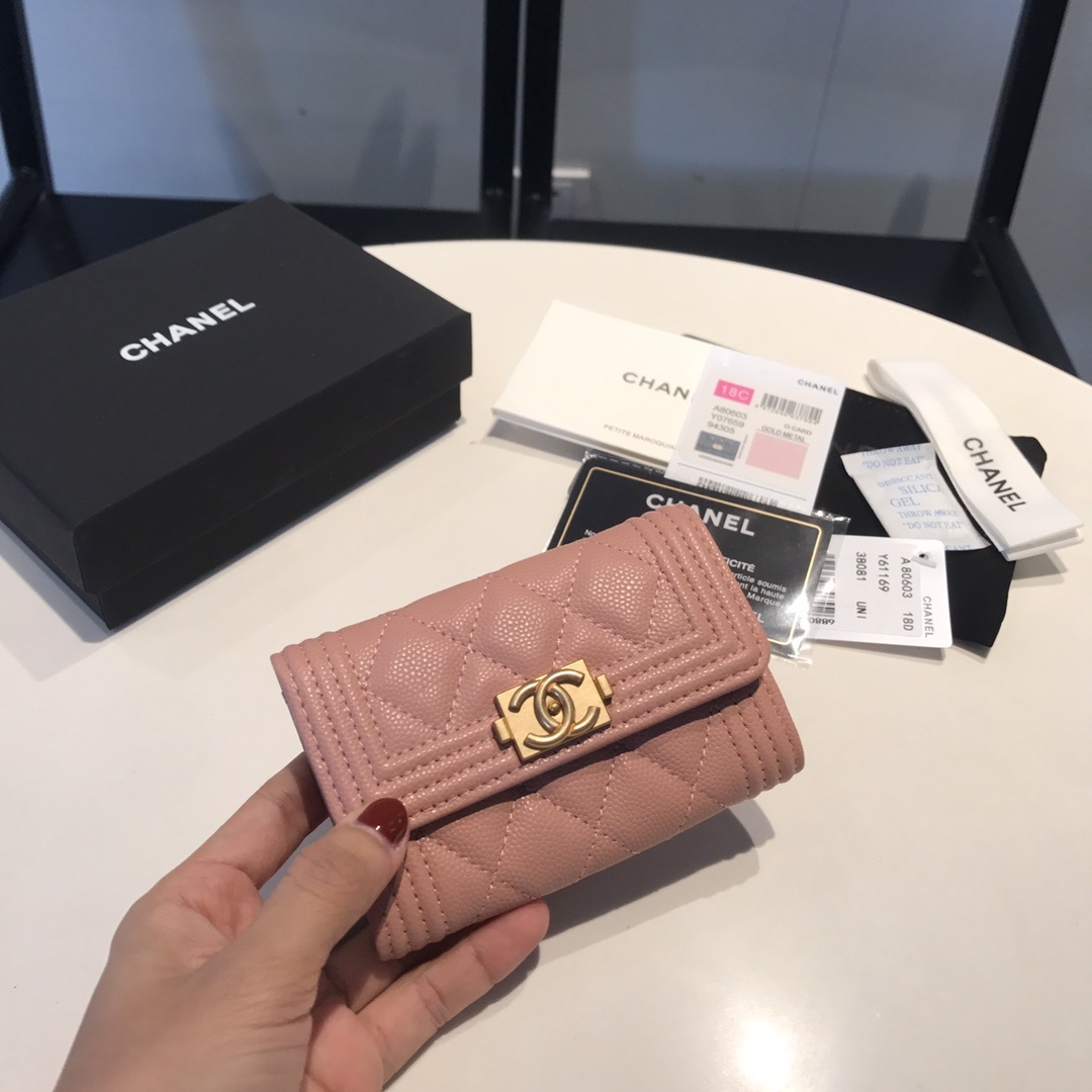 Chanel Boy Small Flap Wallet in a light pink caviar leather with gold-tone hardware.