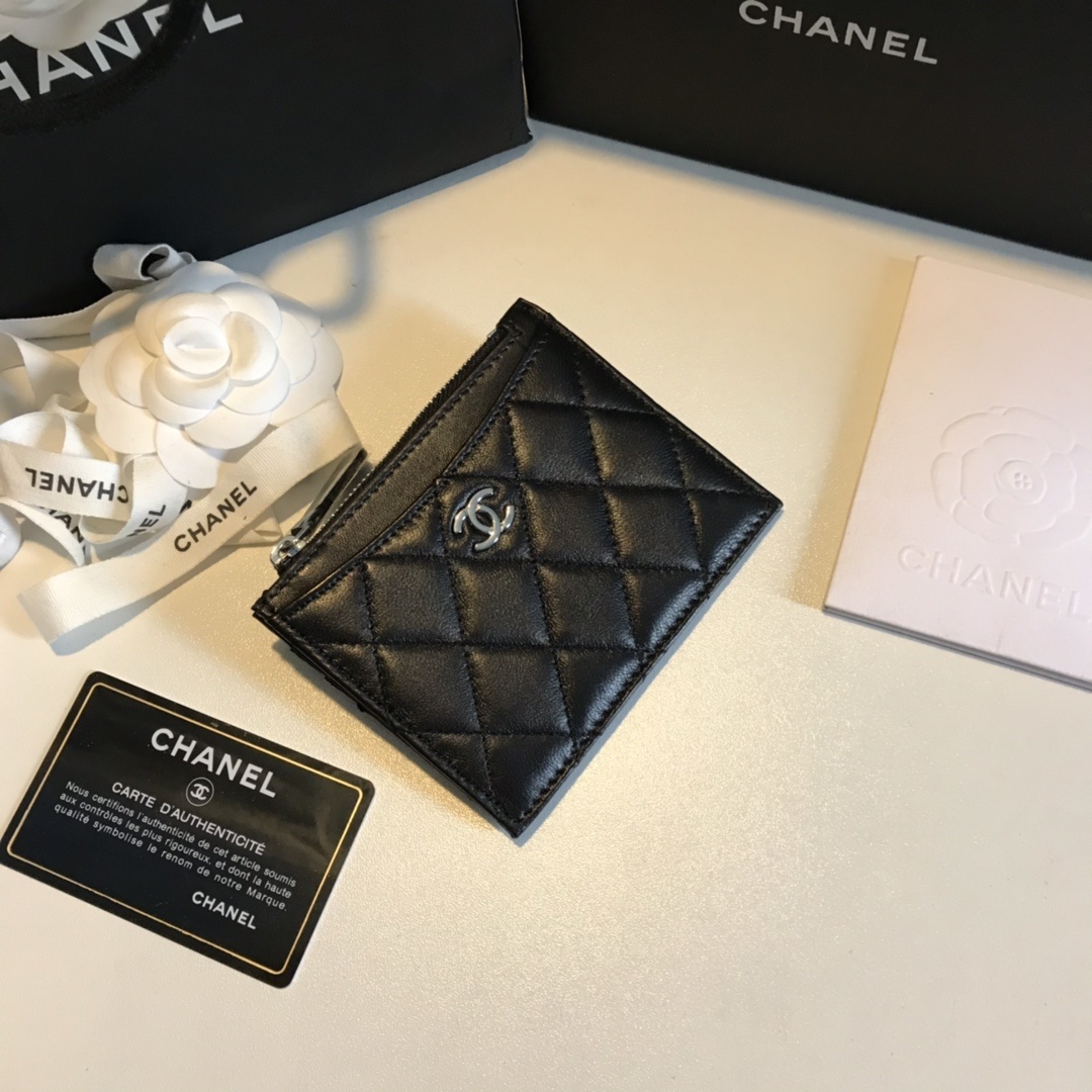Chanel black quilted caviar leather card holder with a silver-tone interlocking CC logo.