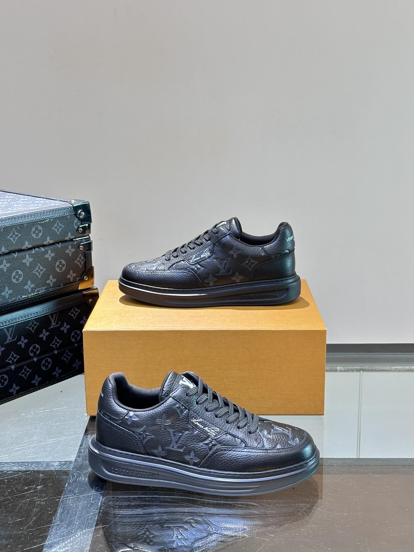 LV Trainer sneaker in a dark blue or black color with a Monogram pattern