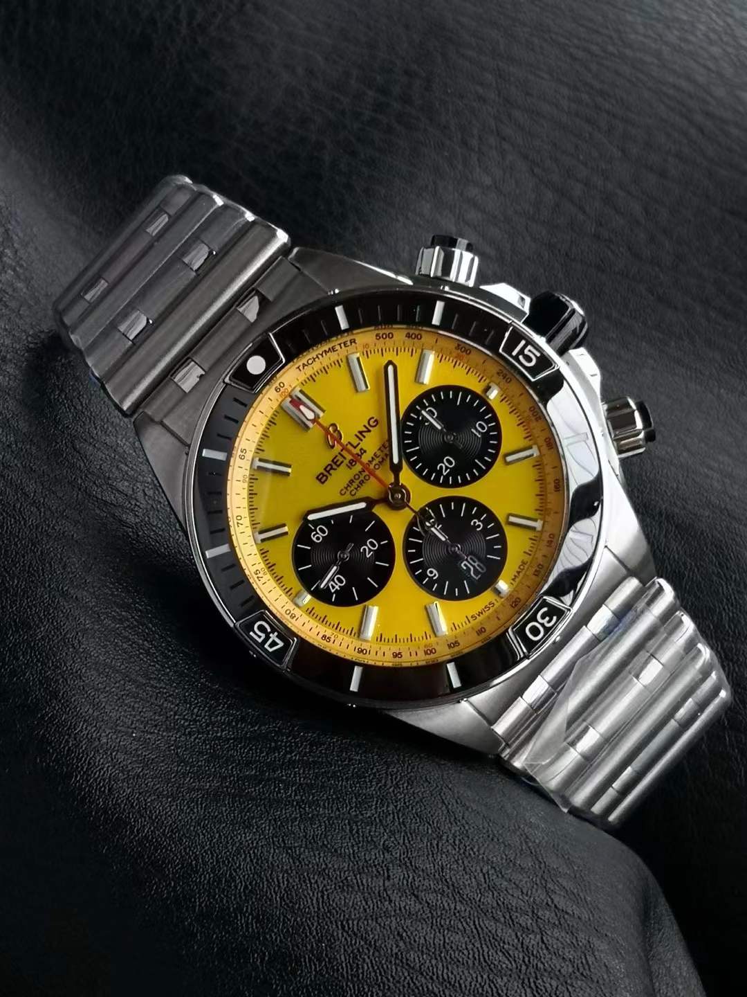 Breitling Super Chronomat B01 44 watch with a yellow dial and a stainless steel Rouleaux bracelet.