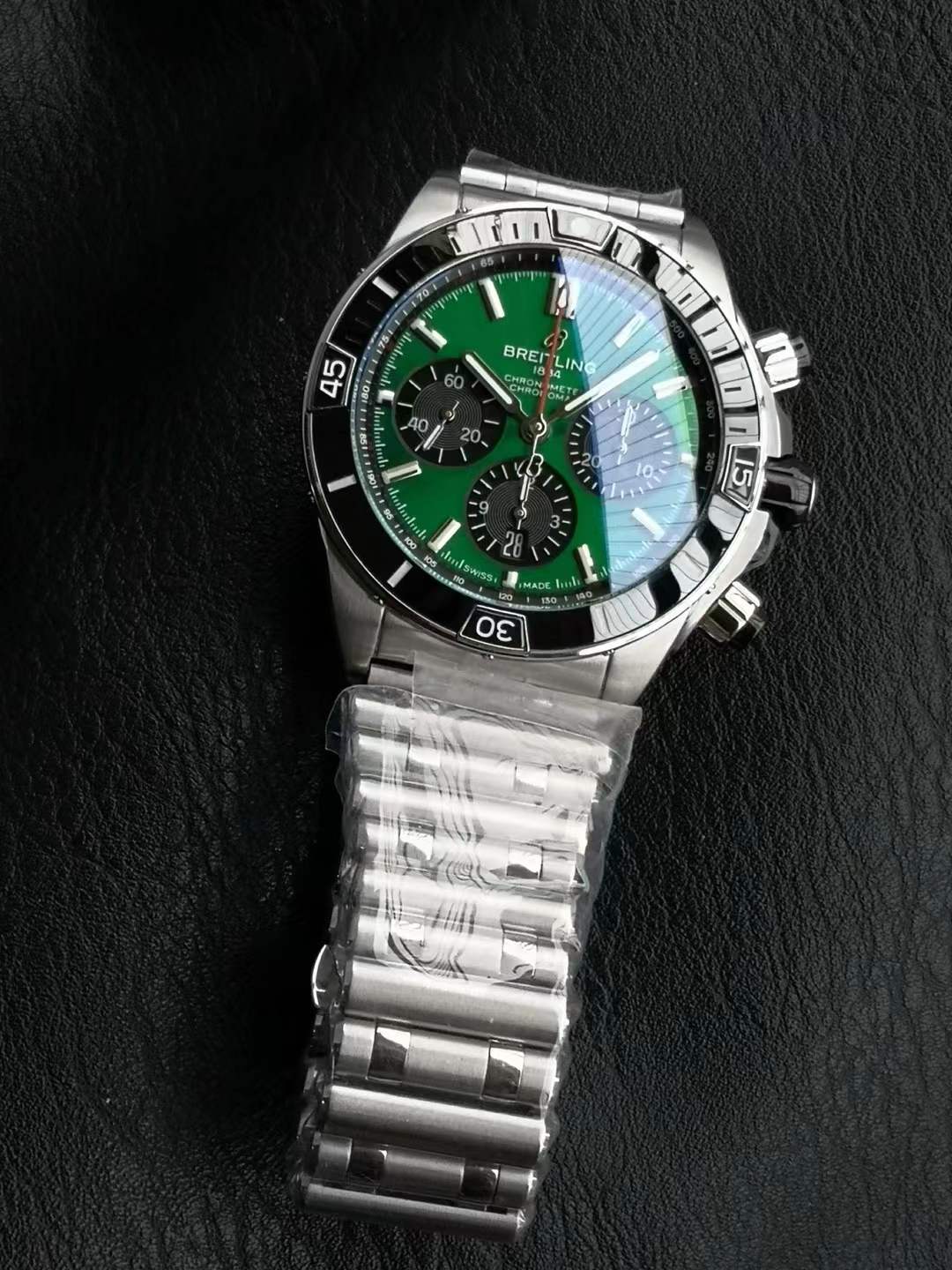Breitling Super Chronomat B01 44 in stainless steel with a green dial and a Rouleaux-inspired rubber strap.