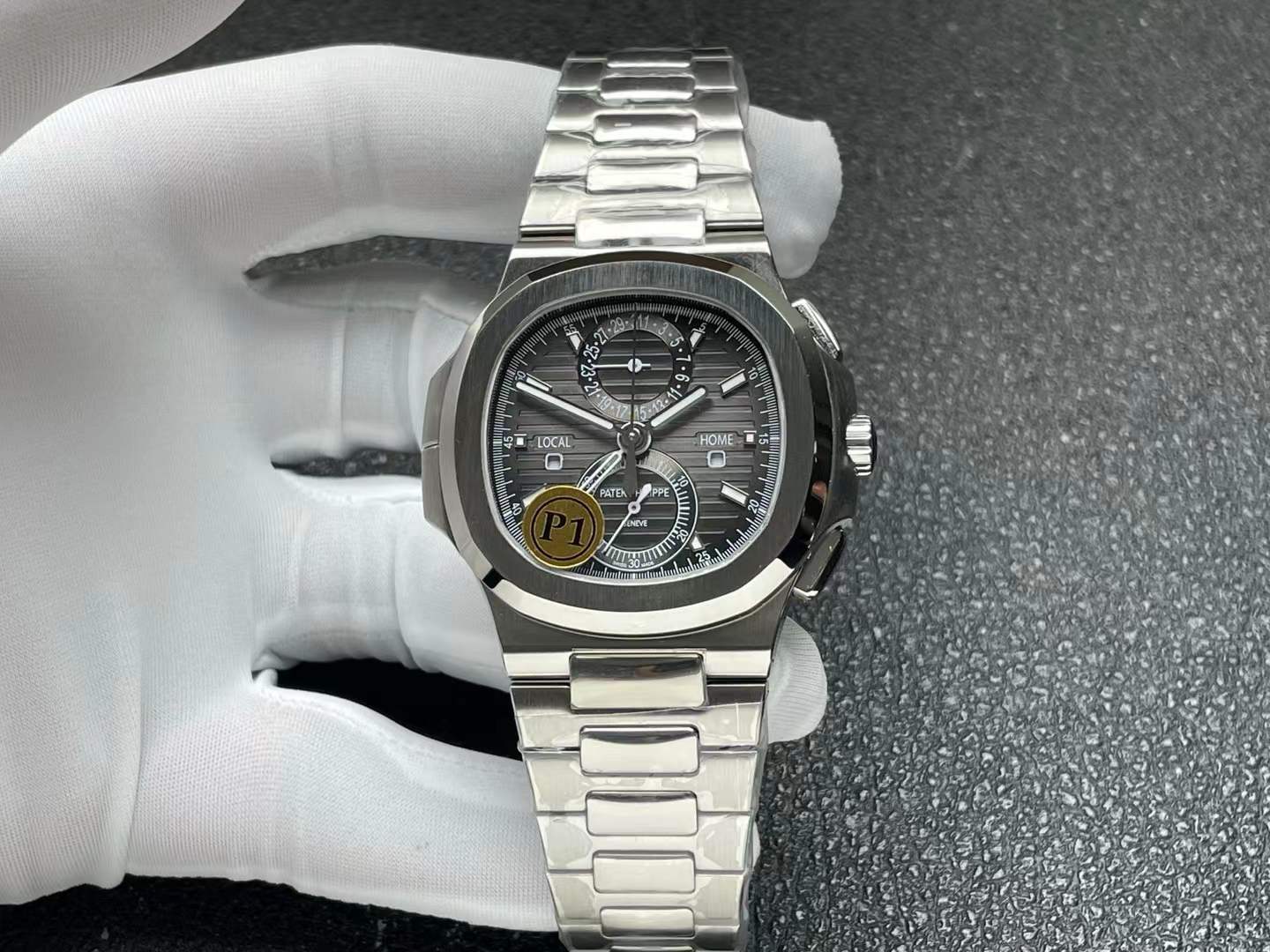 Patek Philippe Nautilus 5990/1A Travel Time Chronograph in stainless steel with a black-gray dial.