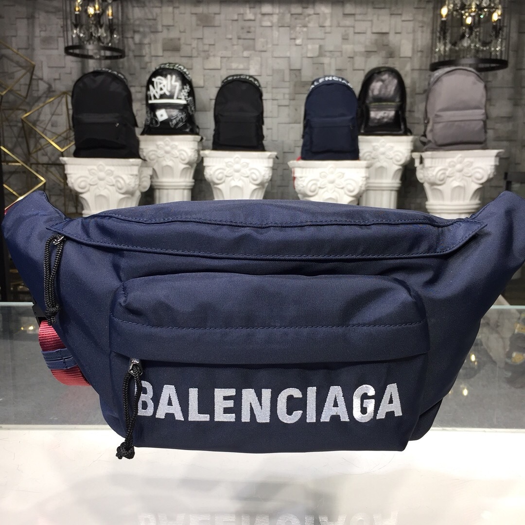 Balenciaga Navy Wheel Belt Bag with a white logo and an adjustable strap