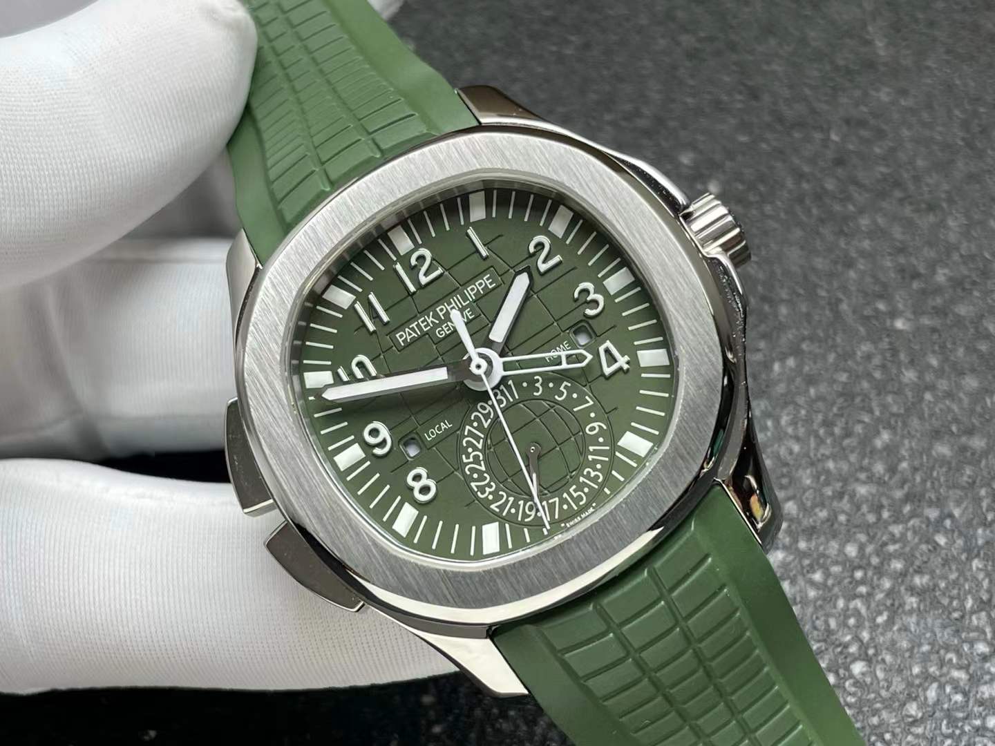 Patek Philippe Aquanaut Travel Time watch with a green dial and green rubber strap