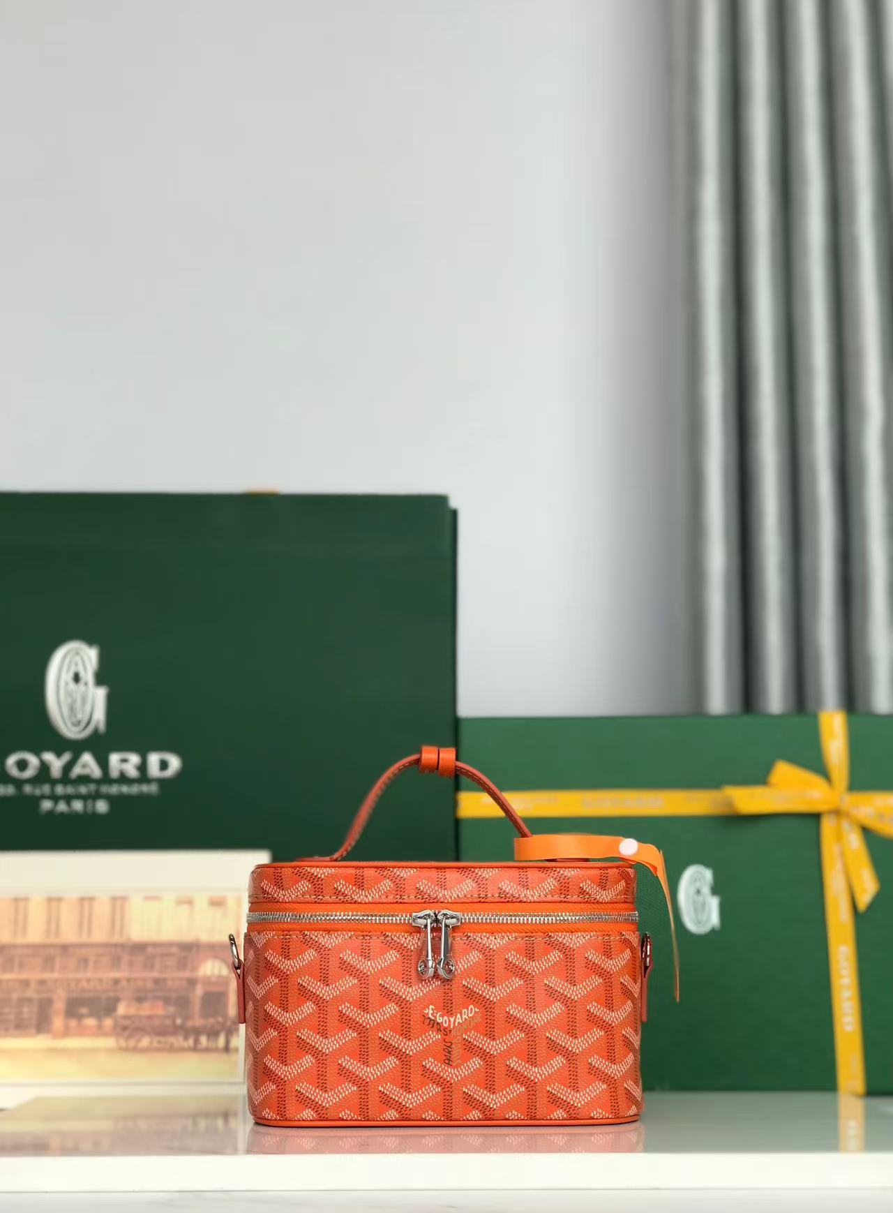 Goyard Muse Mini vanity bag in orange Goyardine canvas with Chevroches calfskin trim and a removable leather strap