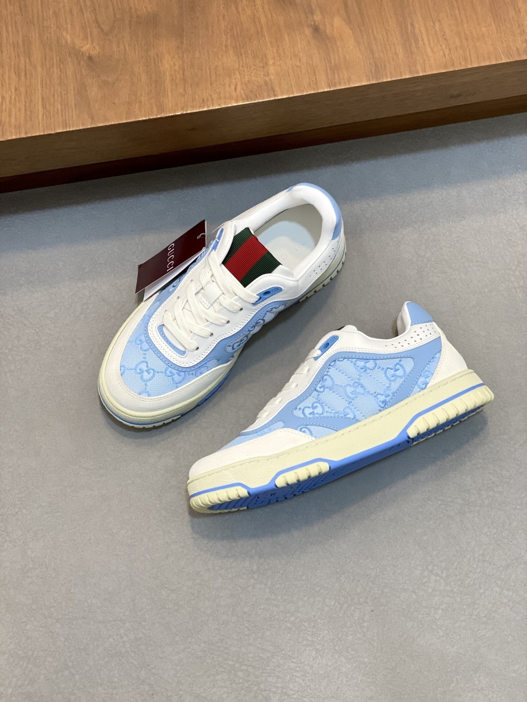 Gucci Men's Re-Web low-top sneakers in light blue GG canvas with leather trim.