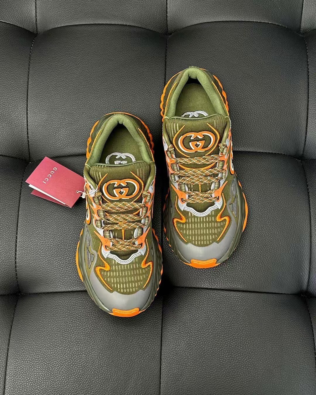 Gucci Men's Ripple Mesh low-top sneakers in olive green and orange.